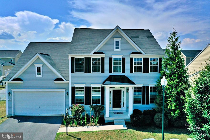 This charming Colonial in Fairfax Crossing just hit the market! The main level features a formal living room or office for those who work from home, a formal dining room, and a family room that opens to the spacious kitchen. The kitchen comes equipped with an island breakfast bar, stainless refrigerator, counter space, and window above the sink that overlooks the vinyl fenced rear yard. Off the kitchen is a butler's pantry with more cabinet space and a pantry area. The upper level features 4 bedrooms, 3 of which have walk-in closets, and an upper level laundry closet. The primary bedroom has a lovely tray ceiling and large walk-in closet. This home also boasts a newly finished basement with durable luxury vinyl plank flooring, beautiful sliding barn doors, a kitchen area (refrigerator included), and a spacious bathroom. This would be the perfect space for an in-law suite! Fairfax Crossing has sidewalks throughout for your morning or evening strolls plus a community playground. This is a commuter friendly location, just off WV-9 and is close to plenty of shopping and restaurants.