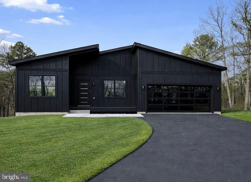 READY NOW!!!    This stunning new construction Mid-Century Modern home is Located on a spacious 0.92 - acre lot in the desirable Woods Resort, offering beautiful mountain views . 
The Berkeley floorplan provides over 1,800 finished square feet on the main level, plus an additional 1,800 sq. ft. walkout basement with 9’ ceilings — perfect for future expansion or storage. The exterior showcases black siding for a bold, modern look. Inside features include luxury vinyl plank (LVP) flooring throughout, all-black interior doors with coordinating hardware, and a cozy living room fireplace framed by a black accent wall with wainscoting. The kitchen is equipped with white cabinets,  stainless steel appliance package, and a large center island ideal for entertaining. The spacious primary suite includes a bold black wainscoted accent wall and an en-suite bathroom featuring a barn door and  custom tile shower & modern finishes. Step outside to a 26’ x 10’ composite Trex deck with sleek cable railing, perfect for enjoying the peaceful natural setting. The home is eligible for Class A Woods Resort Membership, which offers amenities to indoor and outdoor pools, a spa, sauna, fitness center, golf courses, tennis courts, and more. Don’t miss the opportunity to own this stylish and thoughtfully designed home—