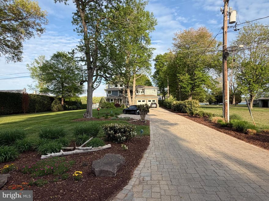 Prepare to be WOW'd by this stunning, custom-built waterfront showpiece where every detail has been thoughtfully curated and nothing is ordinary.  From the moment you arrive, the approach makes a lasting impression -- both private and substantial. The paver driveway with expanded parking, framed by professionally designed landscaping with full irrigation, is anchored by an expansive front lawn for exceptional curb appeal! 

A broad green lawn stretches to the shoreline, creating an exceptional setting for both quiet reflection and gracious entertaining. From sunlit afternoons to unforgettable sunset evenings, every element of the property invites effortless waterfront living.

Inside, a dramatic two-story foyer showcases Brazilian cherry flooring, with inlaid  granite, setting the tone for the artistry and craftsmanship found throughout.

A seamless progression through structure, space, and setting, the home is shaped by natural light, balanced proportions, and an ever-present connection to the water. 

The home unfolds with soaring ceilings, coffered architectural detail, and walls of glass that capture breathtaking water views. Rich textures and bespoke finishes define each space — from stacked stone fireplaces and custom built-ins to statement lighting including colorful glass jellyfish pendants and striking nautical spotlight fixtures that nod to the home’s coastal inspiration.

Designed for both grand entertaining and intimate living, the home features an extraordinary custom bar, wine room, and multiple indoor and outdoor gathering spaces, including expansive decks with sleek cable railings and a screened porch overlooking the water.

The new chef’s kitchen is anchored by a massive center island and surrounded by high-end finishes, seamlessly connecting to the main living spaces. You'll love the lighted glass front cabinets, enormous quartz-topped island,  paneled Miele appliances,  stainless double ovens, commercial-grade gas range, 2 dishwashers, walk-in pantry and more!

The primary suite is a true retreat, offering walls of windows, a tray ceiling, private balcony, walk-in closets, a stacked stone gas fireplace, and sitting area,.  The spa-inspired bath unlike anything else — complete with dramatic stacked stone accents and one-of-a-kind design elements, free-standing, deep soaking jetted tub, oversized seamless glass walk-in shower,  wide-plank flooring & private water closet.  Every bathroom throughout the home is uniquely designed with elevated, custom finishes.

The upper levels continue to impress, including a third-floor suite with panoramic views and a full bath, perfect for guests or a private escape.

The main level also offers a "cabana-style" full bath, just off the patio, as well as a bedroom that could serve as a primary, and a gorgeous screened porch overlooking the water!

Outdoors, the lifestyle continues with multiple boat lifts, jet ski lifts, and private waterfront access, creating a setting that is as functional as it is breathtaking.

This is more than a home — it’s a lifestyle defined by design, waterfront living, and unforgettable moments.

Your private dock awaits you with two jet ski lifts, two boat lifts (20k & 12.5k).  All this and a whole house generator, 2-car garage, water filtration system, security system, AV equipment, TV equipment, and more.
Ideally located within easy reach of Annapolis and Washington, DC, yet wonderfully removed, it offers the rare balance of convenience and true retreat. You won't want to leave!