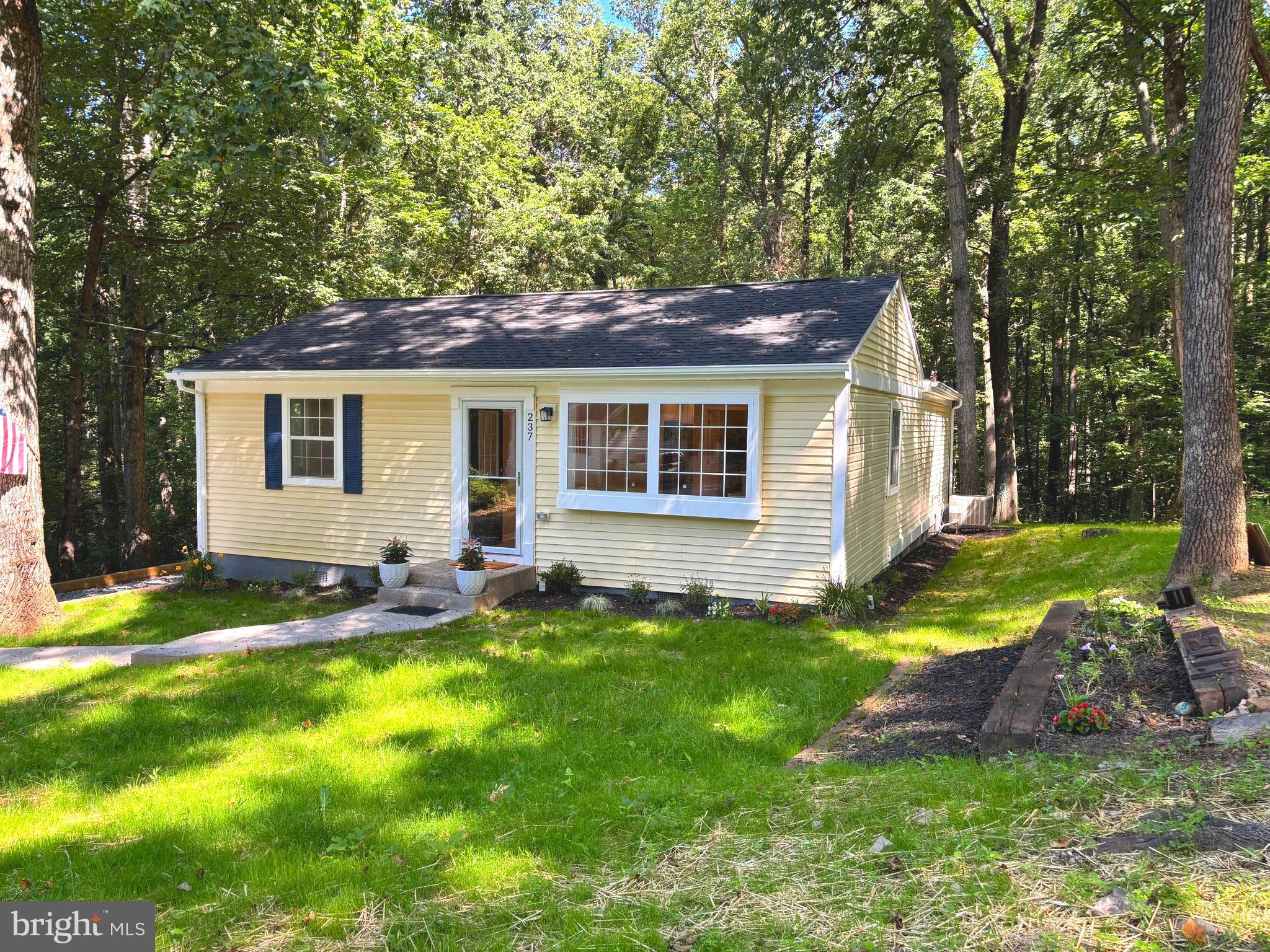 Welcome home to where privacy meets convenience! This completely remodeled home has been turned into a retreat with a large manageable yard that backs to trees on three sides for privacy. Located just off Mission Road, it only takes two minutes to get to the country store or commuter routes via Rt 9, 340 and 115. No detail has been left out, with 2 large bedrooms and 1 small den or guest room, there is plenty of room. The primary bath boasts a double sink, large walk-in shower with a craftsman's touch on the tile work, and barn doors on a closet containing a washer and dryer. The hall bath has a tub and shower with gorgeous tile work. The open floor plan and new white cabinetry in kitchen uplift the living space with plenty of light. Don't forget to check out the floating shelves in the coffee nook! Exit through the french doors onto the new spacious deck, perfect to relax in your private oasis. Parking for at least 3 cars in the driveway and a secondary parking area on the other side of the house for a lease 2 cars, makes having company over a breeze. Located in Shannondale, with no HOA, check out the Mountain Lake Club on 4 minutes away, with seasonal beach and lake use and year round restaurant and community activities.