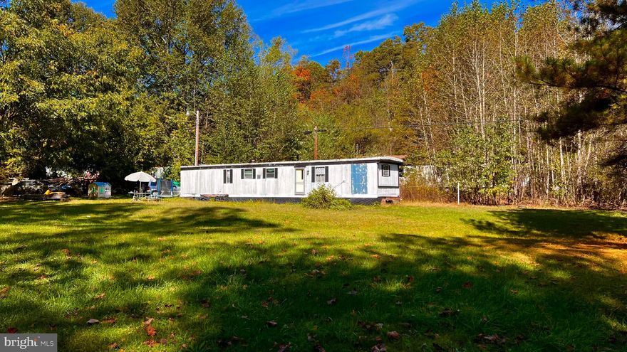Discover 7.28 acres of unrestricted land just 2 minutes off Route 259 in Mathias, WV. This property offers a blend of privacy and convenience, featuring an older single-wide mobile home (sold as-is) with well, septic, electric, and fiber-optic internet already in place. Whether you’re looking to build your dream home, establish a weekend retreat, or set up a long-term site, this lot provides the flexibility you need. Call today to learn more!
