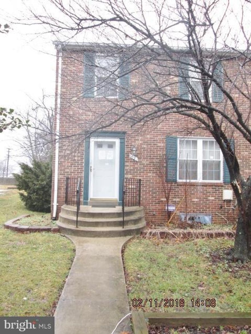 Opportunity to rejuvenate this large end of group townhouse with NO HOA fees! Spacious room sizes- Wood burning fireplace in LR- separate DR- cherry wood cabinets, 3 full BR's on upper level and a finished basement with a full bath. Large lot with deck in rear. 2 parking spots. Great deal for the right buyer. Buyer pays ALL recordation & transfer taxes. Sold as-is.