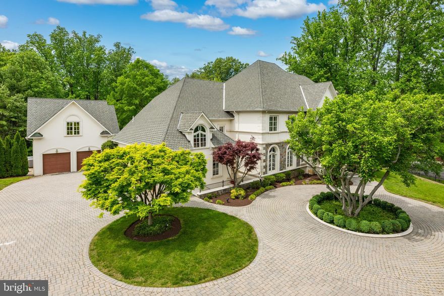 Welcome to this stunning custom residence situated on a gated two-acre lot and boasting a total of seven bedrooms, 10 full bathrooms, and two half bathrooms, with over 14,000 square feet of living space. The property offers an elegant and luxurious lifestyle, with exquisite features including custom millwork, oversized windows, an elevator with access to all four levels, hardwood floors throughout and amenities that epitomize sophisticated living. Upon entering, you are greeted by a grand two-story foyer with an oversized front door and curved staircase, with a formal living room (with a gas fireplace) and an elegant formal dining room on either side. The family room with three sets of French doors and a gas fireplace opens up to an eat-in chef's kitchen equipped with top-of-the-line appliances, a center island, a wet bar with a wine fridge, access to the back patio and a charming breakfast nook. Completing this level is a library/home office with wood paneling and built-in bookcases, a powder bathroom and a conveniently located mudroom off the garages, featuring ample storage, a second laundry room, a full bathroom and a back stairwell. 

The second floor hosts the primary suite, featuring a gas fireplace, a sitting area, two spa-like ensuite bathrooms, and three custom walk-in closets. This level is completed by four additional bedrooms, each with its own en-suite bathroom. The third floor boasts a large bonus room with additional storage. The lower level is designed for entertainment, featuring an oversized recreation room with a fireplace, a custom-built bar, a theater room, an additional bedroom with an ensuite bathroom, a half bathroom, and a bonus room (perfect for a home gym). The detached pool house is complete with an indoor lap pool, sauna, full bathroom and French doors opening up to the outdoor pool. The second level of the pool house is the perfect guest or in-law suite with a kitchenette, living room, bedroom and full bathroom. 

The private fenced-in backyard offers multiple flagstone patios, a tennis court, an outdoor pool, and water fountains, creating an ideal space for outdoor gatherings. Completing this home are three attached garages, two detached garages and a circular driveway with additional parking. Enjoy living within close proximity to Potomac Village, and easy access to Washington D.C. and Virginia. This remarkable property offers an unparalleled blend of elegance, comfort and entertainment, making it a true oasis.