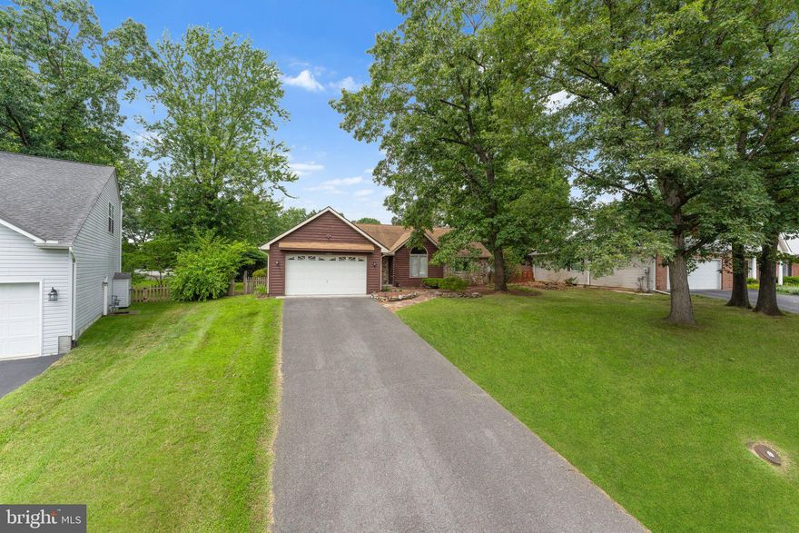 **We've received tremendous interest in this wonderful home and have set a DEADLINE of SUNDAY at 4 PM for all offers. We're looking forward to finding the next owner who will love and care for it just as much.** This charming, move-in ready rambler in Winchester offers a bright and open floor plan that feels instantly like home. Hardwood floors flow throughout the main living areas, while brand-new carpet in all the bedrooms adds a cozy touch. The heart of the home is the spacious living room, where vaulted ceilings and oversized windows fill the room with beautiful natural light. Just off the living room, the kitchen features stainless steel appliances, ample cabinet and counter space, and convenient access to the laundry room. A formal dining area opens onto the back deck, perfect for relaxing evenings or weekend gatherings overlooking the fully fenced backyard. The main-level primary suite offers a walk-in closet and a private bath featuring dual sinks, tile flooring, a separate standing shower, and a jetted soaking tub. Two additional main-level bedrooms each offer their own charm, one with a beautiful palladian window and hardwood flooring, the other with soft carpeting and generous closet space. The second full bathroom has been tastefully remodeled with modern tile, a custom vanity that adds both charm and storage, and a tub/shower combo.
Downstairs, the unfinished walk-up basement offers plenty of space to grow. Whether you're envisioning additional bedrooms, a rec room, home gym, or hobby space. There's also a rough-in for a second laundry area, adding extra convenience and flexibility. A two-car garage provides ample space for parking and storage. Recent updates (2025) make this home truly move in ready and include a new dryer, kitchen faucet, kitchen disposal, updated toilets, and fixtures in the primary bath. Polished hardwood and new carpeting add the perfect finishing touches throughout. A radon mitigation system is already in place and the roof was replaced in 2011. If you're looking for a place that’s been lovingly maintained with plenty of room to settle in and make your own, this is it!