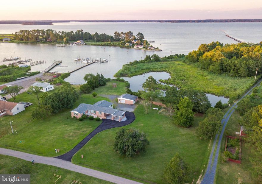 Come visit this well maintained brick rambler with loads of charm on our beautiful St George Island. Waterfront in both front and back--the front of home faces a pond, while the backyard faces the Island Creek, which leads out to the Potomac River. Paved driveway guides us to two attached carports as well as detached garage with additional storage. The interior is open and bright with wonderful water views. This home offers exceptional opportunities to enjoy nature at its best, in a serene environment tucked at the end of a quiet street. If fishing, crabbing or boating appeal to you, look no further.  Sale to include additional lot, parcel 13 (2+acres). This could be your new home, just in time for summer! Priced well below recent appraisal-come take a look.