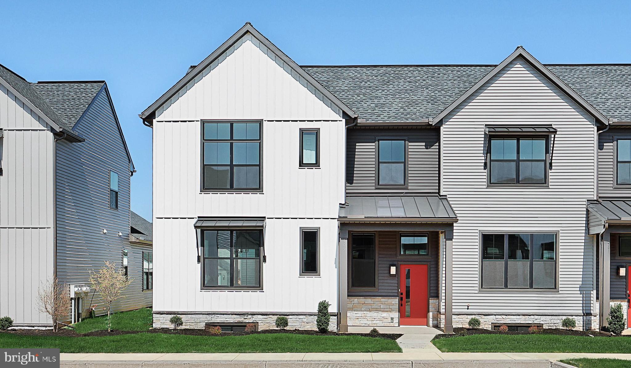 This 2-story, end-of-row townhome includes a first-floor owner’s suite, 2-car, rear load garage and a mudroom entry with built-in lockers and bench. Beautiful vinyl plank flooring adorns the main living areas on the first floor. The living room, accented by a stone fireplace, opens to the kitchen and dining area with sliding glass door access to a patio. The kitchen is well-appointed with stainless steel appliances, quartz countertops with a tile backsplash, and large center island. The owner’s suite, tucked quietly to the back of the home, features an expansive closet and a private bathroom with a tile shower and double bowl vanity. A laundry room is conveniently located across the hall from the suite. On the 2nd floor is a loft, two additional bedrooms, and a full bathroom.