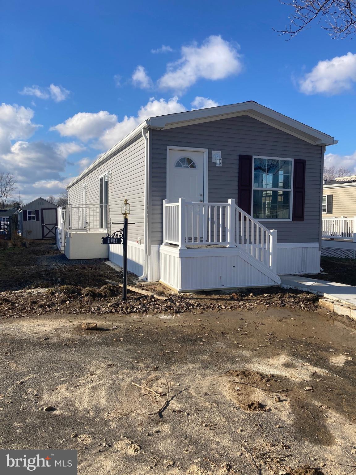 Brand-new, energy-efficient 2 bedroom/2 bath home with vinyl flooring throughout is now available for sale in the 55+ Village of Neshaminy Falls. This home with its grey vinyl siding and cranberry shutters will have a front entrance to a roomy living room that opens to the eat-in kitchen with double stain-less steel sink. The kitchen will be equipped with plenty of white cabinets to keep all your essentials and lots of counter space for your work area. Down the hallway there will be an open space for your washer and dryer and a side exit door to your 8 x 8 storage shed. Just off the hallway is a cozy second bedroom and hallway bathroom with vanity, commode and shower stall for your guests. A sizable, primary bedroom is at the rear of the home with a full bathroom and shower stall. Both bedrooms have carpet flooring. Note: This home is currently under construction with anticipated delivery during the summer and settlement by November timeframe --- all dependent on Manufacturer scheduling . Make your appointment now with the Listing Agent for more details.