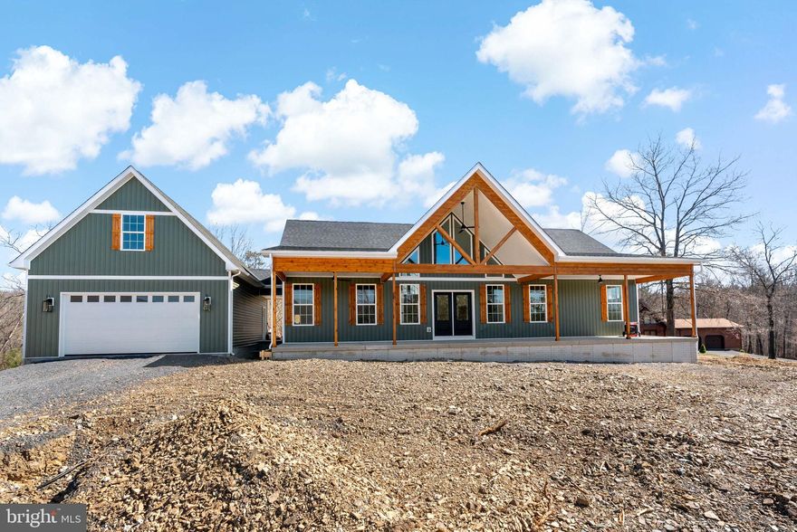 459 Prado  Way, This home will be ready as the final touches of grading are completed with sod and front landscaping. Welcome to your dream home or weekend retreat situated on 1 +/- wooded acres, offering the perfect blend of luxury and tranquility. This newly constructed 3-bedroom, 3-bathroom masterpiece boasts modern amenities and thoughtful design, making it the ideal retreat for those who value comfort and style.

Step inside to discover 9-foot ceilings creating a spacious and airy ambiance. The primary suite is a true sanctuary, featuring a 6-foot tiled shower with dual heads and a rainmaker, a double vanity, and a massive walk-in closet. Cathedral ceilings add a touch of grandeur with beams, while the upgraded kitchen impresses with premium cabinets, a generous island perfect for meal prep and entertaining, butlers pantry and a cozy gas fireplace in the living room.

The living space extends outdoors to a large, covered front porch, crafted with cedar, perfect for relaxing and enjoying the surroundings. The laundry room is a model of efficiency, with a sink and abundant cabinetry for all your storage needs and a rear 12 X 19 deck.

Above the garage, a spacious 14x30 third bedroom with a full bath offering privacy and convenience. The oversized 2-car garage is equipped with jack shaft Lift Master openers for ease of access along with a pedestrian access door.

This home is built for future expansion, with a full walkout climate-controlled basement, 2x6 construction, luxury vinyl plank flooring, tankless water heater, and an oversized heat pump and studded out for future rooms. 

Don’t miss the opportunity to make this exceptional property your forever home. Photos are from a similar home and may have alterations and changes compared to the actual home and square footage will be larger than listed.