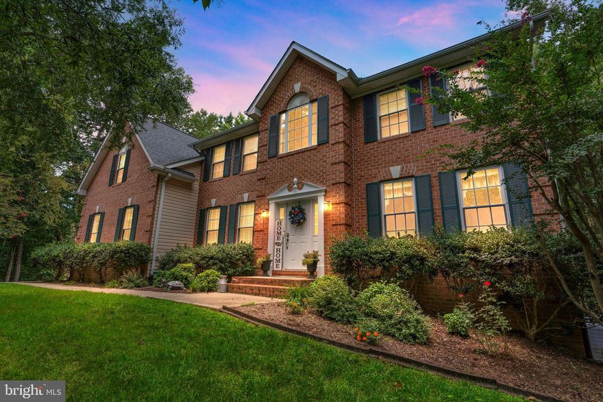 Welcome to your new home in the Avenmar neighborhood of Breton Bay where there is something for everyone, including your fur babies! This amazing QBH Willow model boasts a beautiful brick front Colonial with a sideload 2 car garage that sits on 3.6 acres off of a private road at the end of a cul de sac. The first floor has hardwood and ceramic tile flooring, featuring a bedroom and full bathroom. The family room in this semi-open floorplan has floor-to-ceiling windows that fills the home with an abundance of natural light and a gas fireplace for those cozy nights with the family. The first floor also features a convenient sitting room and formal dining area at the front of the home, and the perfect breakfast area in the kitchen. The kitchen itself has new appliances, a double oven, granite countertops, ceramic backsplash, two oversize pantries and an island with seating.  The second floor can be accessed by two sets of stairs, a set of oak stairs from the front of the home, and a set of carpeted stairs from the kitchen. Head down the hallway that overlooks the living room and foyer to one of three spacious bedrooms, a full bathroom, a beautiful laundry room, and an exquisite owner’s suite. Each of the three spare bedrooms can fit up to a queen size bed with furnishings, and each has a double door closet. The laundry room has been recently updated with a new washer and dryer, cabinets, a custom-made laundry basket holder, and a custom-made murphy table for folding laundry. The owner’s suite provides a luxurious getaway with ample room and an attached sitting room with a bountiful amount of natural light. The ceramic tiled master bath has a private toilet room, an oversized soaking tub, stand-up shower, double vanity and two large walk-in closets. The finished walkout basement also has something for everyone. A private movie room wired for surround sound and insulated with rockwool, a large rec room for family game night, a video game room for the kids (or Dad), a bathroom and two large unfinished storage rooms. There is also a whole home alarm system and a new roof. For your fur babies, an in-ground invisible fence surrounds the yard; ample space for running and playing without the worry of your fur babies running off. Your property also includes a new 12X24 shed, and a large secluded section of wooded area with walking trails that lead to the neighborhood amenities which include a community center, swimming pool with lifeguards, tennis court, volleyball court, tot lot, equestrian center and fields, a fishing/crabbing pier and a boat launch. A little something for everyone in your family!