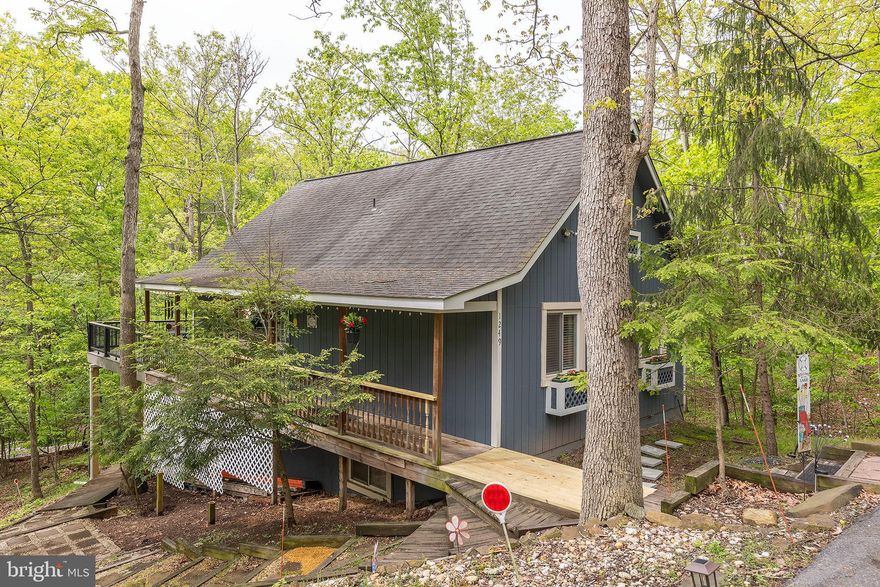 Your cabin in the woods awaits! Snuggle up beside the two wood stoves when it's chilly, and enjoy the expansive deck watching nature and even a little water view when the weather is warm! This rental features 2 bedrooms on the main level along with a full bath and open living area. Stainless appliances in the kitchen, and lots of cute updates throughout! Upstairs you'll find another bedroom in the loft. The basement level features another open living space with flexible use, another full bath, laundry room, and large storage room! The lower level has access to a small patio area and storage under the deck as well, with rain protection to sit and enjoy summer rains! Lake Holiday features 3 beaches, sports courts, a clubhouse, 18 hole disc golf, and more amenities, plus you can bring your boat, canoe or kayaks! Available July 1, must have no credit issues, one small dog allowed, case by case, breed limits, under 20 lbs, must be over a year old, fixed, and vaccinated, non-refundable pet fee of $500