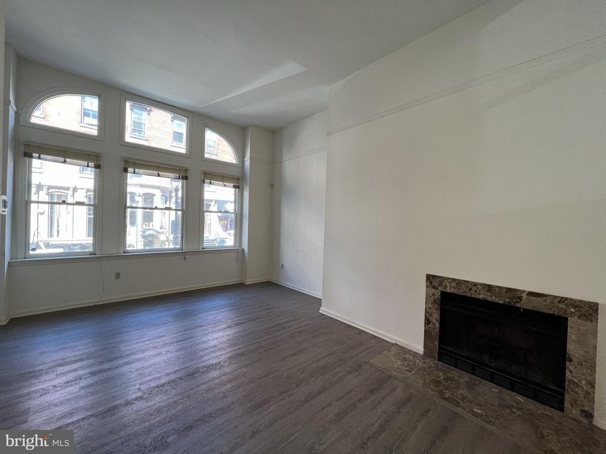 Beautifully appointed three bedroom Wanamaker House townhome with tasteful updates throughout! The home features hardwood floors throughout, with a spacious first floor offering a generously combined living and dining room showcasing a charming fireplace. Adjacent, there is a fully-equipped and recently renovated kitchen with white cabinetry, granite countertops, subway tile backsplash, and stainless steel appliances. The second floor is comprised of two spacious bedrooms with wall closets, which enjoy use of a full hall bathroom with a shower/tub combination. Additionally, this floor has a stacked washer/dryer. There is a lavish primary suite located on the third floor featuring two walk-in closets; another fireplace; private balcony; and ensuite bathroom showcasing a whirlpool tub, shower stall, and double vanity. Wanamaker House townhome residents have access to all the services and amenities of the building while also having the privacy of a single family home. The best of both worlds! The Wanamaker House is located just off Rittenhouse Square; residents enjoy a 24-hour doorman, roof top swimming pool, fitness center, resident lounge with catering kitchen, and on-site garage parking for a fee.