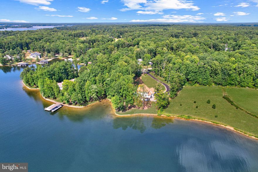 Experience unforgettable sunsets from this turnkey waterfront retreat in the coveted community of Noah’s Landing on Lake Anna. Built in 2023 by America's Home Place, this stunning home is tucked away on a quiet cul‑de‑sac and offers more than 100 feet of pristine waterfront on a generous 0.95‑acre lot. With 2,500 square feet of thoughtfully designed living space, the home features four spacious bedrooms and three full baths across two beautifully finished levels. Step inside to an inviting open‑concept layout where the kitchen, breakfast area, and family room flow together effortlessly. Large windows frame picturesque lake views, while the fireplace adds warmth and charm. The elegant dining room sets the stage for memorable meals and gatherings. From the main living areas, doors open directly onto the expansive deck, creating a seamless indoor‑outdoor experience ideal for entertaining. The deck itself is a true extension of the home—perfect for summer barbecues, relaxed evenings under the stars, or simply soaking in the peaceful surroundings. The treed lot near the shoreline offers dappled shade and a refreshing breeze off the water, making this outdoor space feel like a private sanctuary. The main‑level primary suite is a serene retreat, complete with recessed lighting and a spa‑inspired bathroom featuring a dual‑sink vanity, walk‑in shower, and luxurious soaking tub. Upstairs, two additional bedrooms and a full bath provide comfort and privacy for family or guests. Outside, the backyard unfolds into a private oasis with sweeping water views. There is also potential to build a dock on the right side of the lot—an incredible opportunity for boaters and lake lovers. Additional highlights include a two‑car garage, durable Hardiplank siding, and a 6.5‑foot‑tall crawl space ideal for storing kayaks, canoes, and seasonal items. The 500‑square‑foot PVC deck offers low‑maintenance enjoyment, while the home’s reverse osmosis water filtration system, polishing tank, well, and 60‑gallon pH‑neutral sand tank ensure exceptional water quality. A paved asphalt driveway adds convenience and curb appeal. This premier location offers exclusive access to the community’s private boat ramp, dock, and boat slip, along with endless opportunities for personal watercraft use, canoeing, kayaking, water skiing, wakeboarding, and fishing. With more than 99 feet of shoreline, the property also qualifies for a boathouse up to 2,000 square feet (not to exceed 20 feet in height). And as a final bonus—Firefly high‑speed internet, making remote work and streaming a breeze. This exceptional home offers modern luxury with the tranquility of lakeside living. Don’t miss your chance to own a breathtaking waterfront property in one of Lake Anna’s most desirable communities. TURN KEY READY, ALL FURNITURE + WATER EQUIPMENT, ETC INCLUDED!