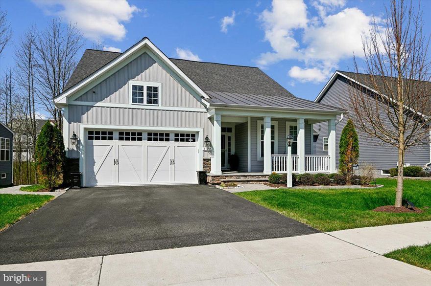 Welcome to the newest listing at the Reserve at Pondview. Looks can be deceiving! This Koch Home Eastport model boasts over 3800 square feet of finished living space, including a large walk out basement with its own kitchenette, living room, play room and bedroom suite. An open floor plan includes a lavish kitchen with massive island, stunning living room with built-ins and a gas fireplace, a dining area with space for a large table, and a den that leads to the deck. The luxurious first floor primary bedroom has a walk in closet with separate dressing area and a walk out to the private rear deck.  The main floor has a 2nd bedroom or office with a full bath. The deck off of the living area provides access to the expansive lower patio, making this home an exceptional place to entertain. A serene setting as the home backs to trees. Two additional upstairs bedrooms with a shared full bath. Take advantage of all the community has to offer including a pool, club house with party area, fitness center, tot lot/playground, and green space around a pond with a pier.