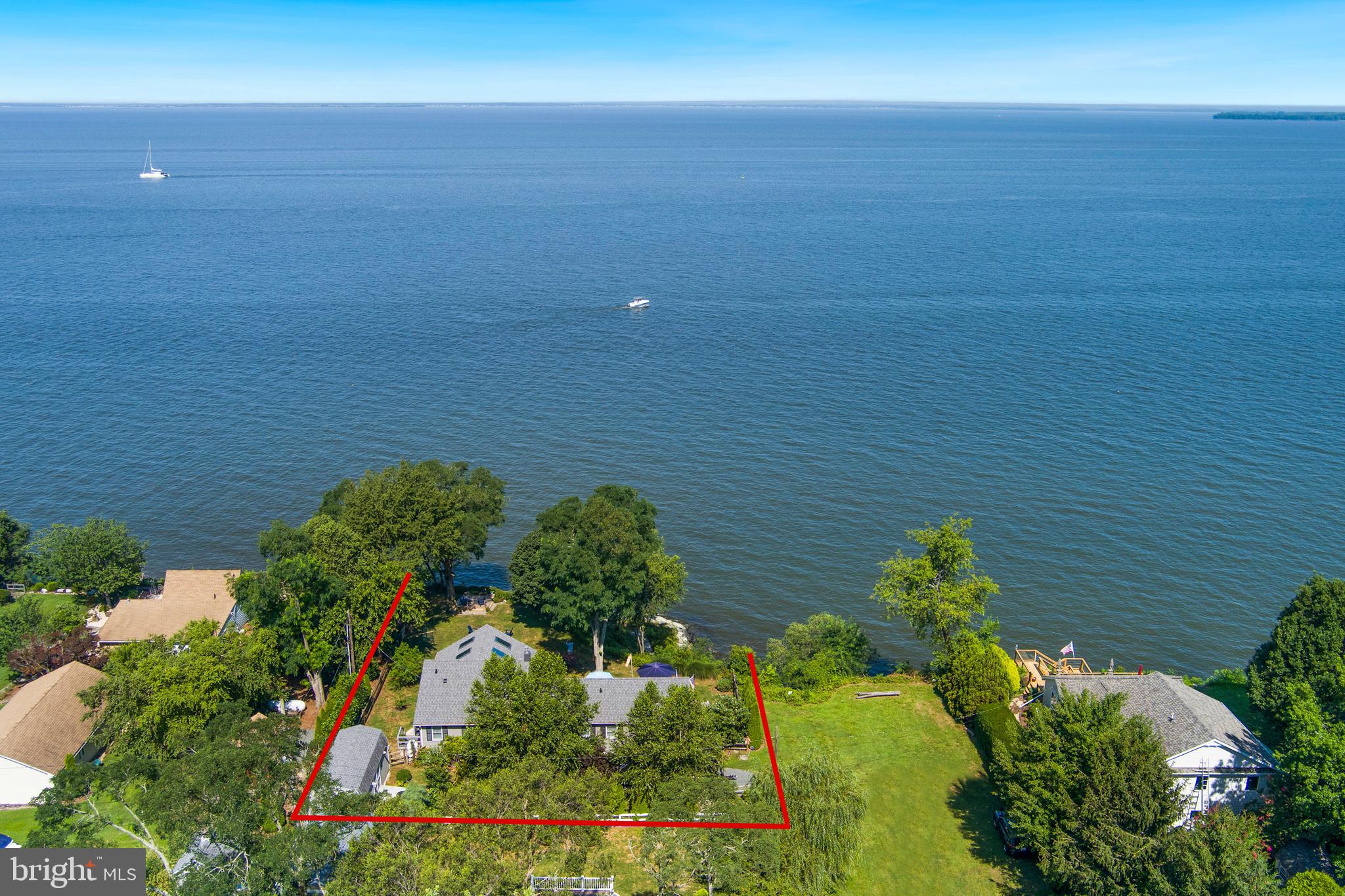 Stunning home and property with 180-degree views of the Chesapeake Bay.
The home was completely remodeled in 2017 by Taylor Loughry Construction. Boasting a bright open floor plan with high-end finishing, vaulted ceilings with skylights, and beautifully landscaped outdoor space.
Two bedrooms and two full bathrooms, open living space with a gourmet kitchen, and a large deck overlooking the Chesapeake. You'll love how the Chesapeake Bay views are framed throughout the home. Enjoy meals on the deck and evenings on the smaller platform deck, perched above the bay. Completely fenced back and side yard facing the water, perfect for pets and some added privacy.
The primary bedroom and bath are spacious, boasting bay views, and sliding doors leading to the deck.
The office nook lends space for some quiet time.
Pull a kayak out and launch on the sandy beach, located down the hill from the home. Launch a boat at the Tolchester Estates boat ramp, or just 2 miles away at the Tolchester Marina.
A short drive to the renowned boating community of Rock Hall, and a 20-minute drive to the charming and historic town of Chestertown. This home is the perfect spot for entertaining and relaxing!