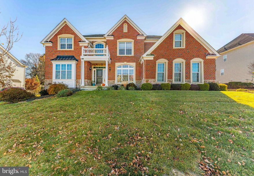 Welcome to 118 Kaitlin Drive, a stunning 5-bedroom, 6-bathroom home located in the prestigious Preserve at Providence community in Collegeville. From its meticulously landscaped grounds to its elegant brick exterior, this home makes an impressive first impression. The expansive driveway with a custom basketball hoop, leads to three separate garages, providing ample parking for multiple vehicles. The garage features a Tesla charger, compatible with various electric car ports. Soaring columns frame the grand entrance. Inside, the two-story foyer with hardwood floors and a grand half spiral staircase that captures the house's elegance and beauty. To the left of the foyer is the expansive custom living room, filled with natural light from windows overlooking the front and side yards. Adjacent to this is a bedroom with access to a Jack-and-Jill bathroom, perfect for guests. The formal dining room features architectural details like curved walls and leads into the butler’s pantry, which offers dark wood cabinetry, granite countertops, and a stylish tile backsplash. A nearby coat closet and hallway lead into the heart of the home: the grand family room, anchored by a gas fireplace and open to the chef-inspired kitchen. The gourmet kitchen is every chef's dream. It boasts a large center island with granite countertops, providing ample space for meal preparation and seating. High-end stainless steel appliances, a tile backsplash, and a walk-in pantry complete this chef's space. Natural light pours in through windows above the sink, creating a bright, inviting atmosphere. The kitchen seamlessly flows into the breakfast room, which features built-in cabinetry, a desk area, and easy access to a second staircase leading up to the upper level. The breakfast room also opens into the sun-drenched sunroom, with its bay shape and sliding doors that lead to a custom two-level composite deck, perfect for outdoor entertaining. The mudroom connects to the garage and a spacious laundry room, complete with tile floors, a utility sink, and plenty of natural light. Upstairs, a balcony overlooks the foyer below. The private primary suite is a true retreat, with a spacious sitting area and plush carpeting. It also includes a bonus room currently used as an additional closet. Two large walk-in closets provide ample storage, while the en-suite bathroom features a soaking tub, a large shower, dual vanities, a linen closet, and a water closet. The second bedroom has its own en-suite bathroom and a pull-down staircase to the attic. The third bedroom shares a Jack-and-Jill bathroom with a bonus room, which could serve as another bedroom. The fourth bedroom is a true suite with its own en-suite bathroom. The fully finished basement is a highlight, offering ample space for leisure and entertainment. The great room includes a wet bar with a granite island, a fridge, sink, and stone backsplash. A playhouse under the stairs, a full bathroom with a unique glass-top vanity, and a utility room complete this level. Beyond the great room, a second family room with access to the backyard offers ample natural light, while the theater room with elevated seating, tray ceilings, and surround sound provides a true cinematic experience. Outside, the private backyard is a peaceful oasis, with mature trees offering exceptional privacy. The two-story deck is ideal for entertaining, with plenty of space for dining or lounging. Located just 5 minutes from local shopping and grocery stores, and offering easy access to Center City Philadelphia, the airport, and King of Prussia Mall, this home combines luxury living with convenience. The neighborhood is safe and community-oriented, making this property a true gem. Don't miss the chance to make this exceptional home yours!