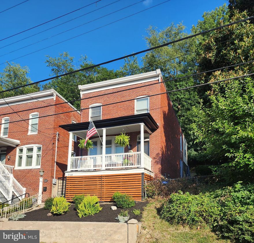 Welcome to 718 Bedford St! You won't know you are within City limits while sitting out back on this double lot property. The peaceful setting is enhanced by the mountainside, shade trees, birds, deer and other wildlife. There are two species of Magnolia trees that provide beautiful blooms. This home has had many renovations and offers an amazing outdoor area. The front of the house was redesigned and offers new horizontal wood planks and new soffit and gutters to give it a more modern look. Main level offers a welcoming entryway with ornate woodwork and leaded glass transom window. There is a sizeable living room with wonderful natural light that's filtered through a triple window with a leaded glass topper, a dining room and galley kitchen, all of which offer updated lighting. On the upper level you will find 3 bedrooms and a full bath. The primary bedroom has a walk-in closet just outside its door, plus an additional closet within. The 2nd bedroom offers a two-part living space. Off the kitchen you will find a covered patio with an outdoor TV. There is a deck with a pergola to one side of the patio and the yard/BBQ area to the other side. There has been professional landscaping in front of the home and nice landscaping/hardscaping features out back. Don't wait! Make your showing appointment today.