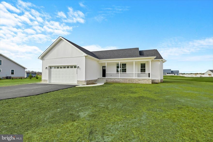 Welcome to your brand-new dream home in the heart of historic Seaford a sanctuary of modern charm and countryside serenity. Move-in ready and set on an expansive 1-acre lot, this stunning modern farmhouse blends timeless design with contemporary comfort. Classic white vertical siding and a welcoming front porch create an inviting first impression, offering the perfect spot to relax and take in sweeping views of the lush countryside and nearby pond.

Step through the front door and into a light-filled, open-concept layout that promises both style and functionality. The main living space flows effortlessly, accentuated by elegant black fixtures, recessed lighting, and ceiling fans throughout, creating a warm and sophisticated ambiance. 

At the heart of the home, the gourmet kitchen shines with durable granite countertops, stainless steel appliances, stylish LVP flooring, and a spacious island that’s ideal for casual seating and meal prep. A large hallway closet offers the potential to become a walk-in pantry. The adjoining dining area is brightened by sliding glass doors that lead out to the backyard.

The serene primary suite is thoughtfully positioned at the back of the home, providing a private retreat with calming views of the expansive backyard. You have a spacious walk in closet awaiting your custom shelving.  Step into the modern ensuite bathroom, complete with a beautifully tiled double wide walk-in shower, granite topped vanity, and a convenient linen closet.  Two additional generously sized bedrooms offer versatility for family, guests, or a home office.

Designed with everyday convenience in mind, a mudroom with easy access to the two-car garage is perfectly placed for entering the home on snowy days, after gardening or outdoor activities. A generously sized laundry room provides ample space for adding custom cabinetry or shelving. The vast backyard is an open canvas, inviting you to create your own outdoor paradise. Whether you envision a garden, play area, or entertainment space, the possibilities are endless. 

Don’t miss this opportunity to own a slice of country luxury, just moments from Seaford’s historic charm. Schedule your tour today to experience this beautiful new home in person! (Note: Select photos have been virtually staged.)