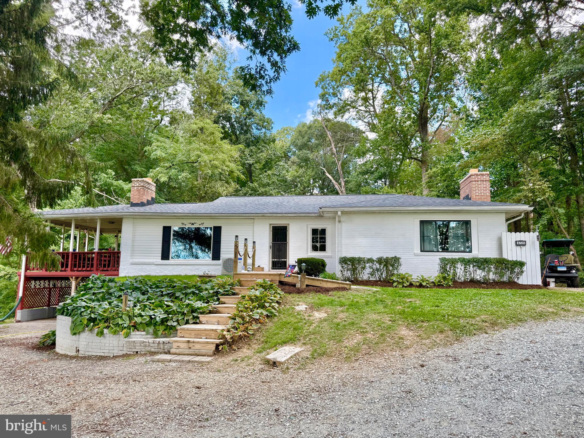 Welcome to this phenomenal 4 bed, 2 full bath rancher on over three acres with woods and trails. This home is 2 in 1. There is a full basement apartment with separate entrance and full service modern kitchen and full bath. Great opportunity to combine households without breaking the bank! Pull into the large circular driveway or park in one of the many parking spaces out front. There is a new wooden ramp leading to the main floor entrance. The main floor houses 3 bedrooms, and a full bathroom with tub/shower combo, a living room and an open concept dining room/kitchen which comes with a non-attached island, all appliances, butcher block counters and deep farm sinks. There is a working fireplace in the living room, and an as-is fireplace in one of the bedrooms. A large covered deck extends off the side of this floor serving as a 3 season room that looks out over the private yard, woods and surrounding farmland. Taking the stairs to the basement brings you to another finished level with its own living area, full kitchen with granite countertops, all appliances and cabinetry. Also on this level is a laundry room, large storage room/worshop, a game room, bedroom and full bath. This floor has its own ground level entrance, making it the perfect in law suite or apartment. Behind the house is a concrete patio that looks out over the cleared portion of the rear yard and surrounding forest. There are golf cart/walking trails all through the 2.6 acres of wooded property. House also comes with two sheds and a chicken coop. The roof is only 4 years old and the exterior will be completely painted white before settlement. This house has been well maintained and cared for and is waiting for you! We will provide passing well & septic reports from 9/25