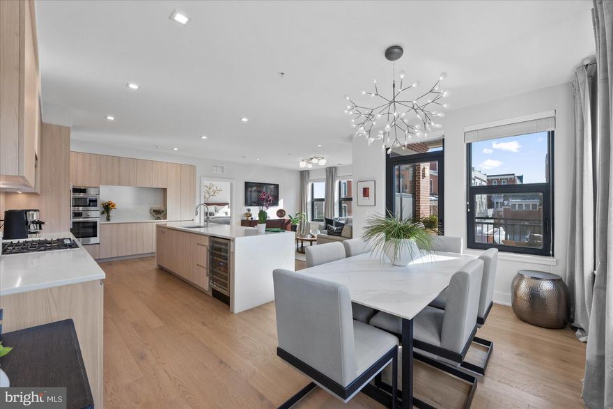 Gorgeous light filled two bedroom condo is the epitome of modern luxury.  As the former model this condo features custom trim and lighting.  Sited on the quiet, residential side of the building and featuring an open, sun-filled floor plan with 9’ ceilings, wood floors, Bosch stainless-steel appliances and Waterworks bath fixtures.  The chef’s kitchen has imported Italian cabinetry, a large quartz waterfall center island, panelized fridge/freezer and abundant storage.   A defined dining area opens to a large balcony offering plenty of seating and overlooking the landscaped courtyard.  The spacious primary suite has two custom closets, one a walk-in, a spa-like primary bathroom with dual sinks, LED vanity mirror and modern frameless glass shower.  The second bedroom features a built-in Murphy bed and storage, perfect for overnight guests while allowing flexibility to use the room as a den or office.   A clever, custom built ‘cloffice’ allows work clutter to be quickly hidden behind closed doors but can easily be re-converted back to a standard closet.  The ensuite bath includes a deep soaking tub.  An oversized garage space and separate, large lockable storage are also included.  <p><p>Dylan at Potomac Yard includes a stunning roof-top party room and patio with breathtaking views of Washington DC, National Airport and the Potomac River.  The patio has numerous seating areas, a fire pit and a gas grill for cooking.  A gym, maker’s space and dog wash station are also available to residents as well as a concierge (7 days a week!)  and on-site management.  The condo fee includes water, sewer & gas. <p>Located in the heart of Potomac Yard, you are just steps away from the Potomac Yard Metro station, CVS, Giant, Target, Founding Farmers and a short walk to the charming shops and restaurants on Mount Vernon Avenue in Del Ray.  Across the street, Potomac Yard Park offers pickleball, tennis and basketball courts.  Dedicated walking and bike paths lead directly to Old Town and National Landing.