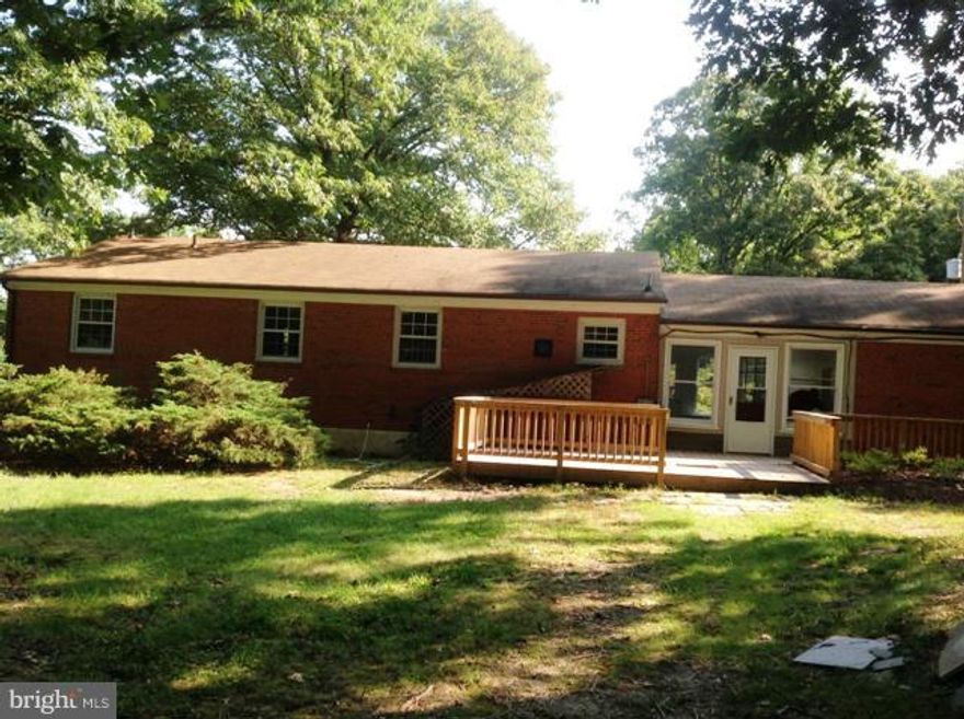All brick rambler in awesome location just 5 min. off Branch Ave/Woodyard Rd exit, hdwood flooring on main level (updated), spacious kitchen, enclosed breezeway, formal dining, decking, back yard to woods, lower level has SUPER BATH & bedroom area, living room w/ Fireplace, storage, laundry.  Home shows well, extra paved parking area Owner motivated