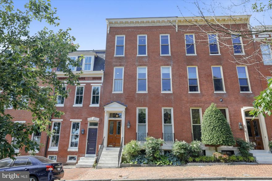 This grand,  4350 +/- square ft home facing Federal Hill Park was lovingly renovated in 2010, with custom mill-work and oak hardwood floors throughout. Attached two car GARAGE. Custom built-ins and storage on every level. Soaring  3 story staircase with original treads and banister. Elevator with custom paneling, gates, and matching hardwoods. Phone system with intercom, music/TV/security system.  First floor has 12 ft ceilings, parlor with gas fireplace, spacious kitchen/dining/family room with gas fireplace. Second floor master bedroom suite with  his/hers walk-in closets and luxe bath with separate shower and tub, double vanity, and heated floor. Two other large bedrooms plus second bath on this level. Third floor library/fourth bedroom, kitchenette/entertaining area, office, and full bath. Lower level game room and half bath. Huge partially covered rooftop tiled terrace complete with plantings, irrigation, and great harbor and city skyline views to the Key Bridge.   Too many special features to include here; please see full list in the documents section.