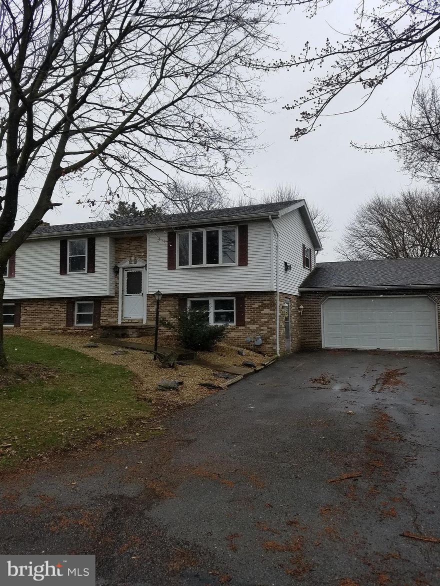 Three bedroom, 2.5 bath Bi-level set on over 1/2 acre lot. Plenty of garage space for the auto enthusiast.  Property being sold in "AS-IS" condition.