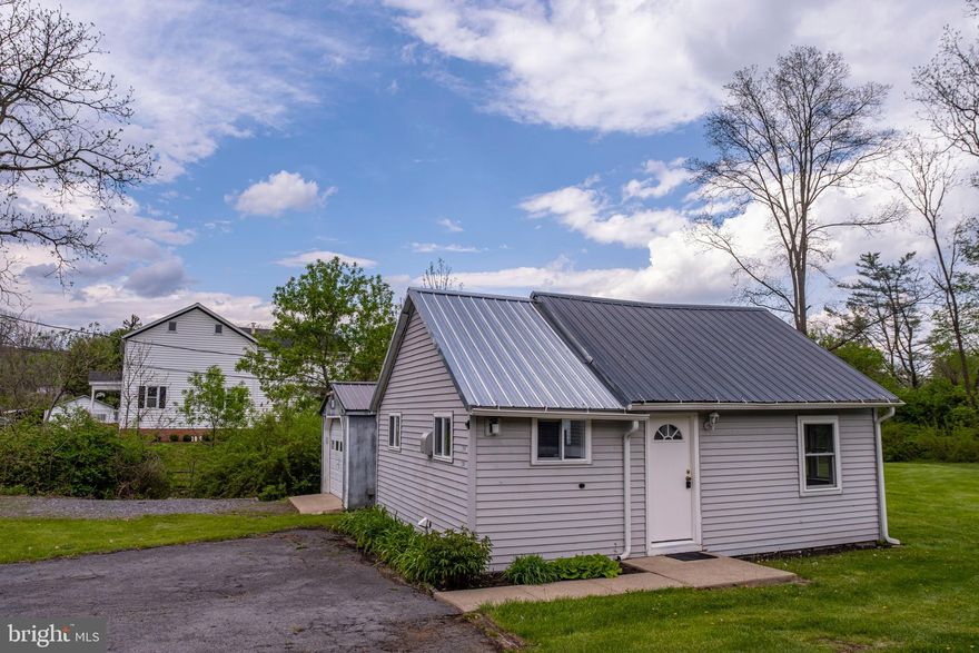 Welcome to your charming new retreat! Nestled on over half an acre alongside the peaceful Spring Creek, this adorable open-concept home offers the perfect blend of comfort and functionality. Inside, you'll find a cozy kitchen and an inviting bath, both thoughtfully designed for everyday ease. The moderately sized main living space seamlessly combines the living room, bedroom, and dining area, creating an airy, versatile layout ideal for relaxed living. Enjoy brand-new carpeting underfoot, abundant natural light through new windows, and the peace of mind that comes with an updated metal roof. Outside, the property offers plenty of room to roam with a handy shed for storage and a garage for your projects or parking needs. Whether you're looking for a weekend getaway or a full-time home, this sweet property offers the perfect escape with the soothing sounds of the creek as your backdrop.