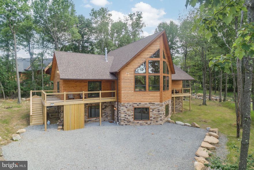 Luxury cedar chalet in the heart of Deep Creek Lake. This custom lodge sits beside the ASCI whitewater course, placing you in the center of Garrett county’s year-round outdoor scene and just minutes from local shops and restaurants. The community trail gives direct access to Wisp on one side, and Fork Run’s 550-acre nature preserve on the other. Finished in 2022, the home was crafted for open-concept living with two full stories of light and space. Vaulted ceilings and a wall of glass on the chalet’s prow pull in the mountain setting and set the tone the moment you walk in. Two large primary suites and four spacious en-suites, make the layout ideal for multiple families. Hardwood floors, granite counters, and stainless appliances blend rustic warmth with modern comfort. Stacked-stone fireplaces anchor both the main living area and the lower-level rec room. An established vacation rental, “Alpine Summit” grossed over $75,000 in its first full year on the market! You do not want to miss one. Call today to schedule your private showing!