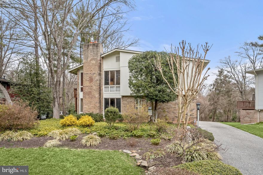 ***Offer deadline Tuesday, March 5 at noon*** Nestled on nearly a quarter acre lot in Potomac’s coveted Red Coat Woods neighborhood, 10609 Great Arbor Drive presents a stunningly updated and meticulously maintained Mid-Century Modern home in a sought-after locale. Spanning 4 levels and 3,568 total square feet, the refined 4 Bedroom, 3 Full Bathroom residence boasts incredible scale and timeless design notes to include soaring cathedral ceilings, gleaming hardwood floors, and abundant windows flooding the interiors with natural light. Lending a seamless synthesis of ageless beauty and modern luxury, this special home features remodeled Bathrooms, a fully finished Lower Level, remodeled Primary Suite and home improvement updates to include newly installed security cameras and motion sensor lighting, new roof and gutters, attic and crawl space insulation, and a whole house generator. Outside the stunningly curated interiors, a private outdoor oasis awaits. Boasting Rear Decks on all 3 Upper Levels, breathtaking vistas of the property’s lush, landscaped grounds and the backing parklands, this suburban sanctuary is the perfect setting to enjoy your morning coffee or gather for a night cap with friends.
Manicured landscaping leads to the residence’s double entry doors, providing a warm welcome to the home’s magnificent offerings. An inviting Foyer adorned with hardwood flooring and exposed brick wall welcome you to the Main Level. Curated for utmost convenience and functionality, the Main Level showcases a sprawling Family Room featuring a gas fireplace with raised brick hearth and surround and access to a private Deck, a discreetly appointed Bedroom, recently renovated Full Bathroom, and a Laundry Room complete with a utility sink and workspace. 
Ascending the stairway, the sprawling Second Level hosts the home’s principal living spaces. Separated by a floating wall the Living and Dining Rooms feature gleaming hardwoods, cathedral ceilings, walls of windows overlooking the rear vista and a sliding glass door lending effortless access to the expansive Second Level Deck. The exquisitely expanded and beautifully renovated Gourmet Kitchen is sure to enthrall any caliber chef or avid host. Adorned with cathedral ceilings, custom maple cabinets, Corian counters, Subzero paneled refrigerator, Dacor 5-burned gas cooktop, JennAir double wall ovens, ample storage, a pantry cabinet and an adjacent Breakfast Area, this Gourmet Kitchen is a true Chef’s haven. Complete with a sliding glass door to the Side Deck, outdoor grilling is a breeze for evenings of al fresco dining.
The Third Level presents the home’s private suites to include a remodeled Owner’s oasis. Featuring hardwood flooring, 2 gracious and outfitted walk-in closets, and a French door leading to the Suite’s private Deck, the Primary Suite’s amenities don’t end here. The en suite Primary Bathroom lends a relaxing sanctuary within the residence, boasting a floating dual vanity, a stall shower with a steam feature, rain shower head, and handheld shower head. Two additional Bedrooms and a renovated Full Bathroom complete the Third Level’s offerings.
The multifunctional Lower Level boasts ample space to fit the new owner’s needs with a flexible and expansive floor plan. The fully finished level currently showcases a large Recreation Room or Office, and an additional Bonus Room or Home Gym with built-ins and a large storage closet. To round out the level’s offerings, a French door off the Recreation Room leads to the Driveway and Breezeway to the home’s 2-Car Garage. Seller is conveying a one year home warranty with AHS (American Home Shield) to buyer