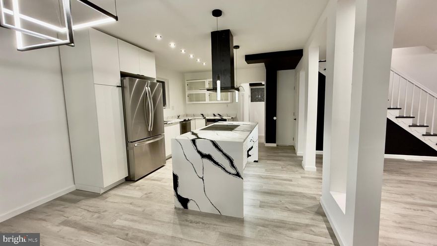 Welcome to this stunning 5-bedroom, 2.5-bathroom luxury residence, where modern design meets everyday comfort. This home showcases an open-concept architectural layout, perfectly blending elegance and functionality to create an inviting atmosphere for both living and entertaining. Step inside to discover a spacious contemporary interior , abundant natural light, and premium finishes throughout. The kitchen features a striking open-concept layout with sleek white cabinetry, stainless steel appliances, and bold waterfall-style quartz countertops accented by dramatic black veining. The large island includes built-in storage, a cooktop, and a stylish black range hood, complemented by modern pendant lighting. Light wood-style flooring and recessed lighting enhance the bright, elegant atmosphere.The expansive living and dining areas flow seamlessly, enhancing the home’s open and airy feel. The private family Room will make movie night’s espectacular. Half bathroom located on the fish floor. Second floor you will find   4 bedrooms , the main bedroom with walking closet and bathroom the common bathroom continues the same design contemporary aesthetic, featuring large marble-look tile walls, a floating vanity, a modern square sink with a matte black faucet, and a frameless mirror. The 5th bedroom is located on the third floor. New  HVAC system fueled with Natural Gas for heating and Central A/C for cooling. New water Heater. New Electrical System. New plumbing system. Everything is new. Outside, you’ll find a beautifully landscaped yard ideal for relaxation or entertaining.  A shed perfect for your storage  needs.  Garage for one car and 2 car space driveway . Every detail of this home has been carefully curated to deliver style, sophistication, and modern comfort—a perfect choice for today’s discerning buyer.