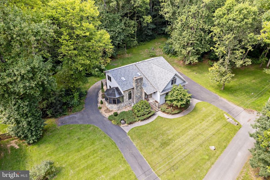 Welcome to this stunning contemporary stone-front home located in the pristine and highly sought-after neighborhood in Inwood, West Virginia. Situated on a sprawling 1.28-acre corner lot within a peaceful cul-de-sac, this home offers space, privacy, and a lifestyle of luxury.  This beautiful  4 bedroom, 2.5 bath home features an open floor plan with cathedral ceilings. There are 2  primary bedrooms, one conveniently located on the first level with a kitchenette, providing flexibility for larger families or guest accommodations. Enjoy cozy winter nights by the grand stone fireplace or relax in either of the 2 sunrooms, filled with stunning natural light.  The spacious and open kitchen is a chef's dream, offering ample cabinets and counter space, making it perfect for entertaining. Additional highlights include a huge bonus room above the garage, ideal for a game room, man cave, or extra living space.  Recent upgrades include a NEW roof with skylights, a NEW HVAC system, and an upgraded water heater. A whole-house water filtration system and water softener have been added.  The huge walkout unfinished basement awaits your finishing touches.   The large and spacious garage with epoxy flooring is perfect for mechanics and outdoor enthusiasts. The wraparound driveway offers ample additional parking that is perfect for hosting events.  For added peace of mind, this home comes equipped with a hardwired 17KW LP generator and a 500-gallon tank, ensuring you’re always prepared. This home is truly perfect for those who love to entertain and appreciate a blend of beauty, function, and peace of mind in one of the area’s most desirable neighborhoods.