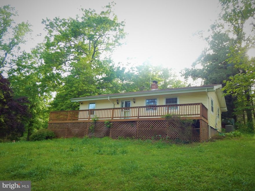 PROMISING 2 BEDROOM/1 BATH RAMBLER SITS ON  2 PRIVATE ACRES.  JUST RIGHT FOR A STARTER HOME, OR DOWNSIZE.  HAS SEPARATE LAUNDRY ROOM,  EAT-IN AREA OFF KITCHEN.  WRAP AROUND DECK SHOWS MATURE TREES, SLOPED FRONT YARD. LONG PAVED DRIVEWAY FROM ROAD AFFORDS PRIVACY.  HAS A DETACHED 3-CAR GARAGE. GREAT PRICE!