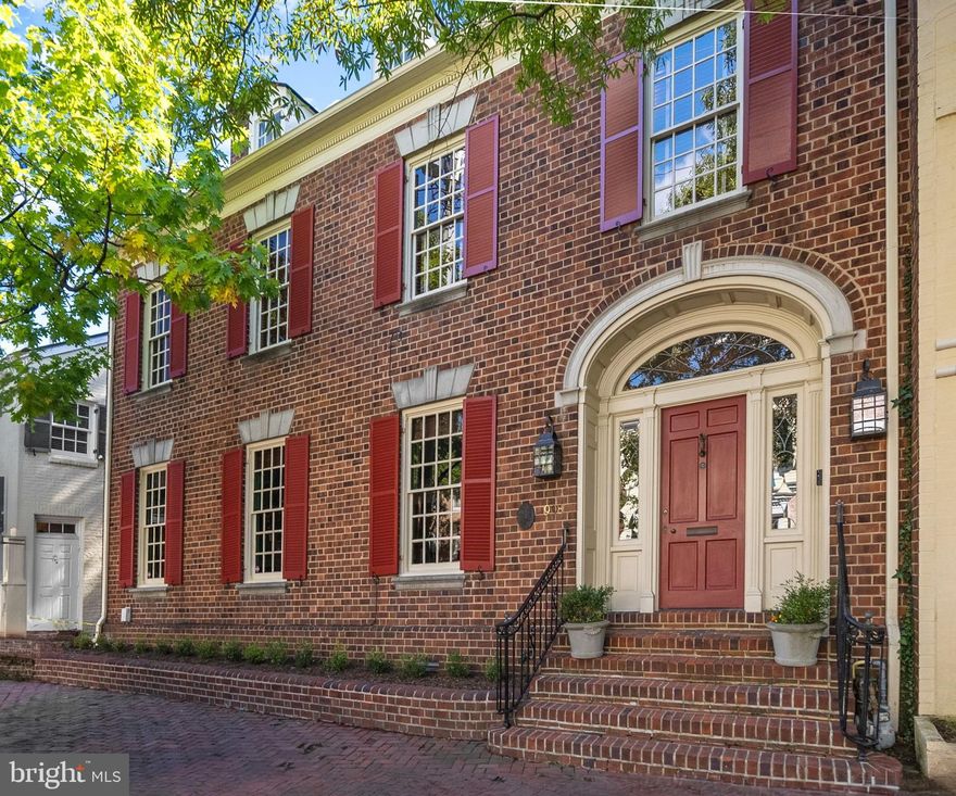 Welcome to 908 Cameron Street, an extraordinary end-unit townhouse in the heart of historic Old Town Alexandria. This 4-level, 5-bedroom, 3.5-bath residence seamlessly blends historic charm with contemporary comforts. Living here offers a rare opportunity to walk through history daily, surrounded by iconic landmarks like George Washington’s church and beautifully preserved buildings. Stepping out onto the sidewalk feels like stepping into the past, making this home an experience most people can only imagine. **The home features high ceilings, intricate moldings, and solid construction that evoke elegance. Grand, spacious rooms provide an ideal setting for entertaining, while the spectacular private outdoor space—a lush garden oasis—offers a peaceful retreat in the city's heart. The distinctive architecture of Old Town, with its unique patina, enhances the home’s atmosphere. **The opulent living and dining rooms flow seamlessly into one another, creating a warm and inviting space. Both rooms feature stunning marble-surrounded wood-burning fireplaces with lovely mantels, adding a sense of timeless beauty. The dining room is further enriched by unique built-in shelves, perfect for displaying cherished, one-of-a-kind pieces.
**The kitchen is a chef’s dream, equipped with top-of-the-line Miele and Bluestar appliances and premium finishes. It provides a sophisticated, almost European-style setting. Most of the major systems and appliances are less than five years old, ensuring comfort and ease of maintenance. Throughout the home, hardwood floors, crown moldings, arched doorways, historic paint colors, and thoughtful details balance traditional character with modern amenities. **The primary suite offers a serene retreat and a recently renovated ensuite bath. The top-level 5th bedroom/loft, used by the current owners as a studio or office space, provides excellent versatility and ample storage. Off-street parking for two cars adds convenience—an invaluable feature in Old Town. **Beyond the home itself, the location is unparalleled. Walk to nearby restaurants, bars, and shops, leaving the hassle of commuting or driving behind. 908 Cameron Street's unique blend of history and modern comforts makes for a truly distinctive living experience. **This home offers a rare opportunity to live surrounded by history while enjoying all the conveniences of life today in one of the most sought-after neighborhoods in the country.