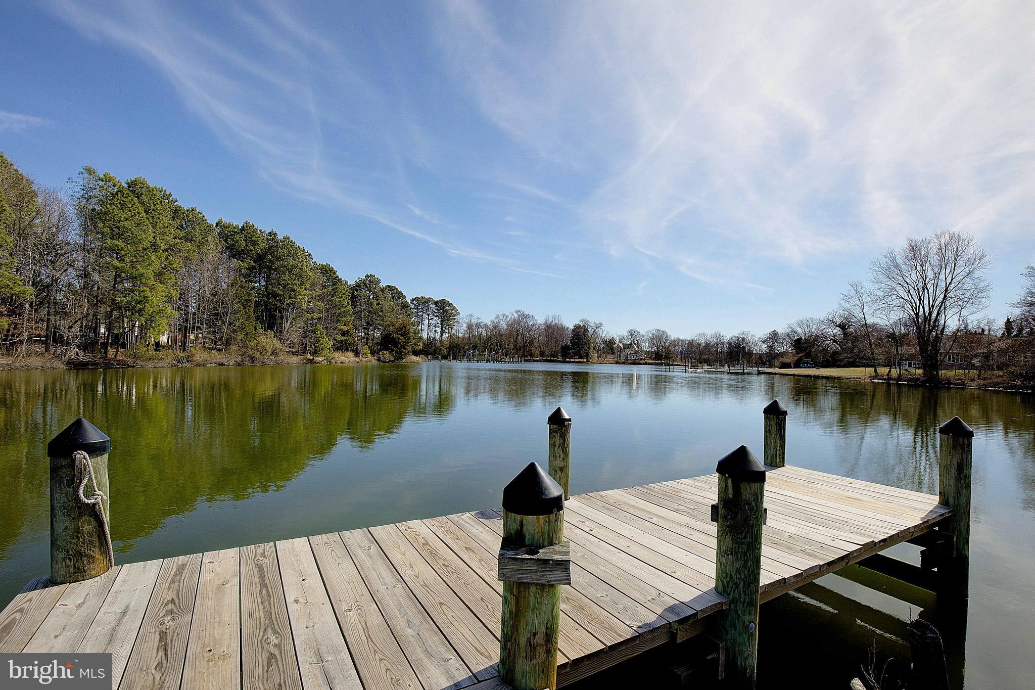 This Cape Cod is located on a 1-acre waterfront lot on Saint Patrick's Creek. Bring the boat! It's the perfect location for boosting in the sun, fishing, and crabbing. It has an extensive pier and floating dock that was recently resurfaced w/ marine pressure-treated timber. It spacious with 4 Bedrooms 3.5 Baths. The home features two main-level master bedrooms with ensuite bathrooms. The bathrooms are a must-see w/ marble tile, high-end fixtures, and unique vanities. The kitchen overlooks the water w/ luxurious soft-close cabinetry, stainless appliances, and a polished Waterfall quartzite kitchen countertop. The living room has a built-in fireplace for entertaining your guests. If you need more capacity for enchanting your guests enjoy a breeze on the upper deck w/ cocktails or the lower screened porch for a picnic. Additional storage space at the rear of this property. There is an extensive shop w/ newly installed exterior doors and a garage door at the rear of the property. The shop has a separate electric meter from the house that can be utilized as residential or commercial. Please contact SMECO for more information regarding the classification. Do not miss the opportunity to own a home that features a modern open floor plan with a kitchen, dining room and living room space set for entertaining. This property is being sold “as-is” condition. Recent appraisal available for review upon request. Are you ready to call it Home Sweet Home! Call today to setup a private showing!
