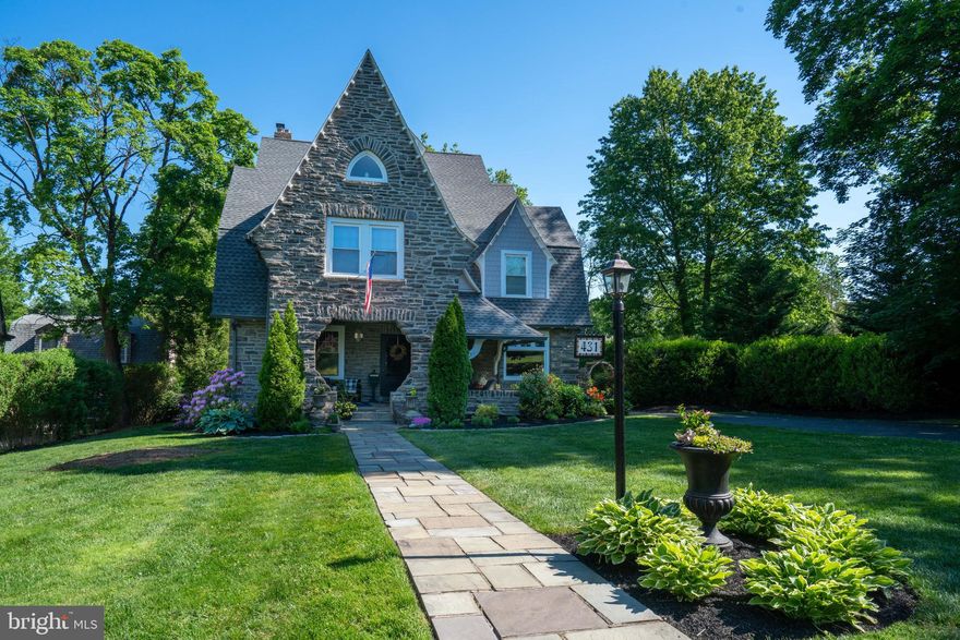 This distinctive storybook Victorian in Wayne, lovingly cherished and cared for, is available for the first time in decades. A true charmer, with its stone exterior and location on sought-after Midland Avenue, it is within easy walking distance to all that the town has to offer, including boutique shops, bakeries, and restaurants, Radnor Trail, and so much more. the appeal of Wayne is difficult to overstate, with its community spirit, tree-lined sidewalks, and neighborhood vibe. This well-loved home, which couples original charm with modern amenities, is ready for the next buyers to create their own happy memories. Rich in history and with many architecturally interesting details, this welcoming home in Radnor School District awaits its next owner!  Enter this lovely home through a beautiful stone archway that greets you with its spacious front porch. The front door opens to a vestibule and reception hall with views of the elegant staircase. To the left of the hall is a spacious and welcoming living room; on the right is the parlor that can be used as a library. The reception hall leads to the formal dining room as well as the large breakfast room with built-in bar. The updated galley kitchen features ample cabinets and counter space, as well as appliances. The pretty staircase leads to the second level. The main bedroom on the left has an adjoining bathroom with large dressing room. The other three bedrooms on this level also have access to a second full bath, with stall shower and claw-footed tub. There are two additional bedrooms on the third level, as well as a bonus room. Ideal for a yoga studio, it also is easily convertible to a home office or other creative space. The third level also has two separate storage areas. The exterior is perfect for entertaining. Enjoy summer evenings on the front porch or on the rear deck with awning, overlooking the swimming pool. The rear yard also has a patio and fire pit for cozy, outdoor visits. This well-positioned home on Midland Avenue, surrounded by prime real estate, is also close to the Wayne Art Center and Wayne Hotel, Chanticleer Gardens, and Township parks. It is an easy commute by road or rail to Center City, corporate centers, Main Line universities, and is in the highly regarded Radnor School District.