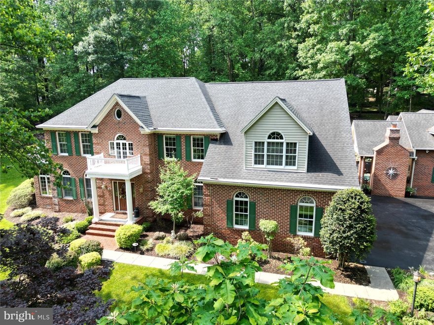 Perched on an elevated lot and surrounded by 2.7 acres of natural beauty, this custom-built brick colonial offers a peaceful sanctuary with the conveniences of nearby amenities. Enjoy the sights and sounds of nature all while being just minutes from shopping,dining and major transportation routes. Step inside to find thoughtful and tasteful updates throughout including a stunning Brothers gourmet kitchen (2019) featuring white cabinetry, quartz countertops, SS GE appliances and induction range-perfect for the home chef.  The renovated primary bathroom(2019) is a spa-like escape with an oversized walk-in shower, double vanities and custom tile. Major system updates give peace of mind,a new roof (2017), and dual HVAC systems (2022 & 2024). The backyard is a showstopper, highlighted by a gorgeous saltwater pool surrounded by professional landscaping and hardscaping. This ultimate entertaining space features an indoor bar/kitchen which spills out to an outdoor vaulted ceiling covered patio with  fireplace, TV  and full bathroom. pool pump (2023). For the car enthusiast or those needing extra space there is a 2 car attached garage and an additional  3 car detached garage complete with approx. 1000 sq ft above the garage. Unfinished space ideal for an office, au-pair suite or in-law suite. Public water and sewer are an added bonus.  This delightful house is in pristine condition and has been meticulously maintained by the original owners