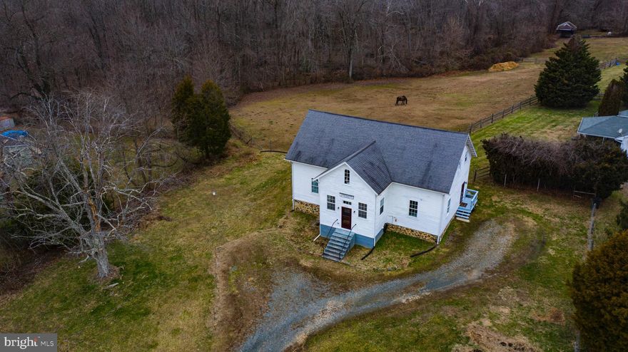 Unique and historic home in close proximity to Furnace Bay Golf Course and just a short drive to the Perryville MARC Train Station, Hollywood Casino, the future Great Wolf Lodge and numerous local and international businesses.  The MARC train provides convenient commuting to the greater Baltimore and Washington DC areas. Once the Whitaker School (1845 -1931), this home consists of two complete living areas (main floor and second floor) which can be used together or separately.  Each has its own electric service and meter.  Many upgrades have been made throughout the years including vinyl clad insulated double pane windows and new insulated exterior and storm doors.  Don't let the number of bedrooms discourage you from being interested.  The downstairs living area consists of a large foyer that leads to an open concept living area consisting of a kitchen, dining area, living area, and sleeping quarters.  There is also a full bath and separate laundry room.  The large downstairs can be used as is, or could be re-designed to have separate rooms such as a first floor bedroom, dining room and/or living area.  The flooring is original hardwood that can be left as-is or refinished to suit a new owner's taste.  A side entrance leads to a second door opening to the downstairs and a stairway that leads to the second floor.  The second floor is a modern separate living area that consists of an open layout with kitchen, and dining area with vinyl flooring and a living room with wall-to-wall carpet.  The space is completed by two carpeted bedrooms and a full bath.  Under the front of the house is a partial basement which houses the water heater as well as a water treatment system and provides storage for bicycles or other outdoor equipment.  The walls of the crawl space are well maintained original stone, and the partial basement walls are block.