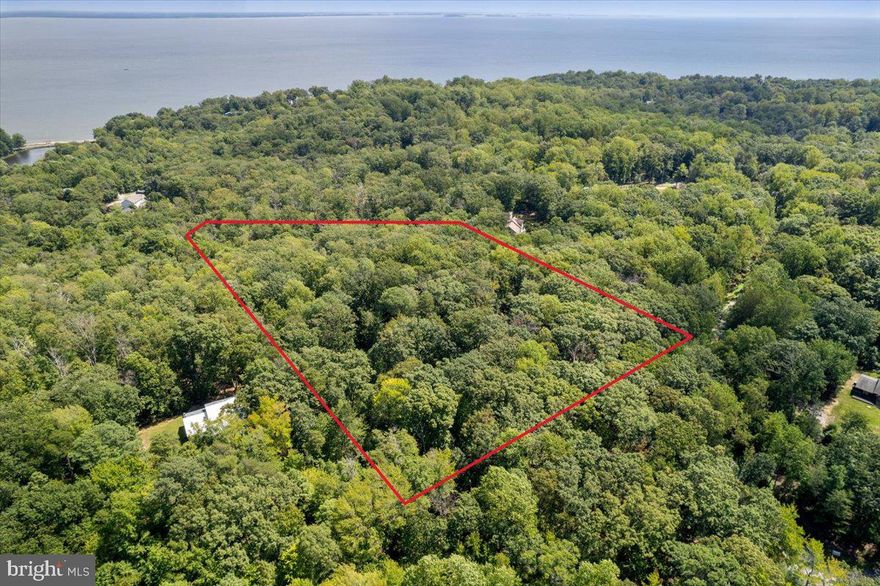Escape to your own private retreat on this stunning 6.2-acre wooded lot, where the sounds of nature and the promise of a peaceful life beckon. This isn't just a piece of land—it's a blank canvas with permits already in hand and a portion of the impact fee paid, making your dream build a reality. The front of the lot is level and ideal for your home's foundation, while the land gracefully descends into a lush, natural forest filled with native trees and beautiful mountain laurel. Imagine waking up to the sounds of songbirds and watching for deer from your future back porch. In this community, you'll also enjoy exclusive access to a private beach on the Chesapeake Bay with a pavilion, offering the ultimate outdoor experience. Survey available by request.