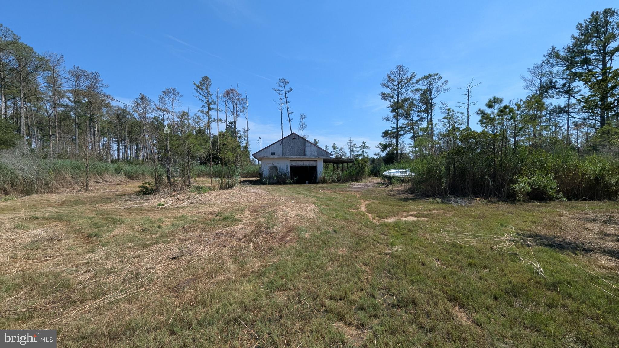 This private 3.06-acre property offers a fantastic opportunity for your future home or retreat. The lot features existing electric service, a well, and septic system already in place. A detached garage with a concrete floor and two overhead doors provides great storage or workshop potential. There’s also a mobile home with an addition on a concrete slab. Abundant wildlife, including deer, frequently visit the property, enhancing its peaceful, secluded setting. The lane is gated with a lock on the chain for added security. Whether you’re looking to renovate or build new, this spacious lot offers the ideal foundation for your vision.