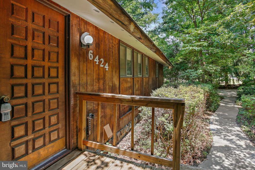 A rare opportunity to own a secluded, one acre lot in the heart of Columbia without the CPRA fees and restrictions. Spacious, open concept, contemporary ranch style home with soaring cathedral ceilings . Tall glass windows provide more natural lighting & a relaxing atmosphere.  Unwind in the 30-foot-long living room in front of custom stone fireplace, overlooking the woods.  The property has been owned and enjoyed by the same family for almost 50 years.  Consequently, improvements and upgrades are needed. Property is priced accordingly and is sold "As-Is".