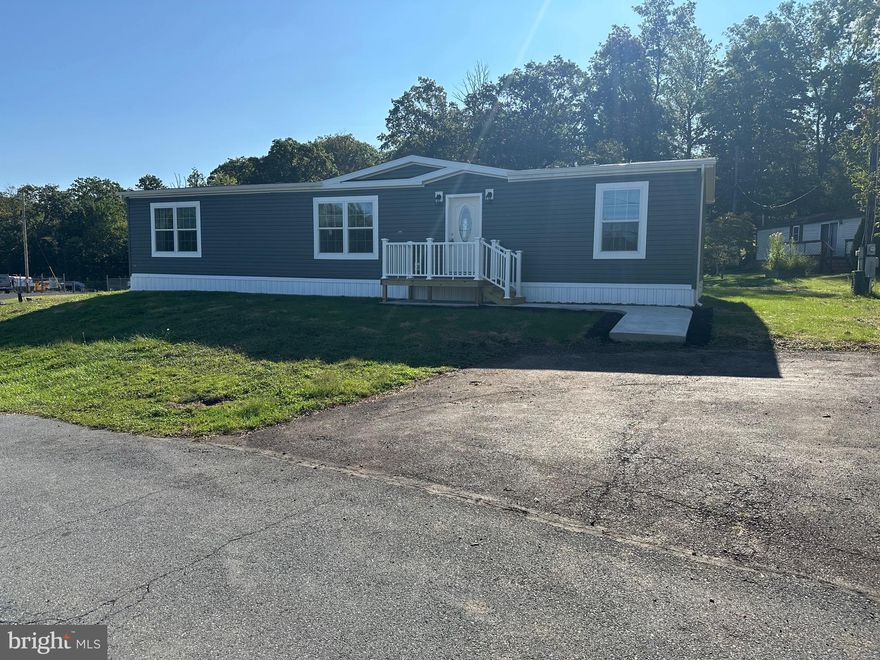 If you are looking for the "wow factor", you've found it! . This home offers spacious, open living , an island kitchen with a surprise pantry cabinet that opens to a utility, pantry ,office combination room. The huge primary bath has a soaking tub and a walk in shower for convenience.  The hall bath has a tub shower.
There is access to the bike/walking trail that goes to Hellertown only feet away. The $ 941 monthly land lease includes 1500 gallons of water/sewer use, the pool, mini golf  ,chip and putt ,  fishing ponds and use of the community pool for private functions.   Park approval required