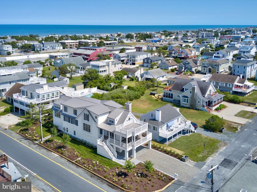 This BRAND NEW home is located in the highly desirable northern part of the town of Fenwick Island. It offers approximately 4,000 square feet of interior space, an additional 780 square feet of deck and porch space, and 720 square feet of garage and unconditioned space for a total square footage of 5,500. Designed for luxury and comfort, the property is situated on a corner lot on the bay block with bay views, just two blocks from the wide and uncrowded Fenwick Island beaches and within walking distance to popular restaurants and shops. This 5 bedroom home features a lavish owner suite ,4 junior suites and an ELEVATOR for convenient access to all levels. The main level primary suite features 2 large walk-in closets with custom cabinetry, a spa-like bathroom with heated stone flooring, dual vanity sinks, marble counters, and a bright and airy shower. Maple hardwood flooring is found throughout the house, complemented by historic wood beams from the 1800s. The modern kitchen features state-of-the art appliances including a Wolf 6-burner gas range with oven, an additional Wolf wall oven, a Sub Zero Refrigerator. The great room with its vaulted ceilings and gas fireplace opens to the large main-level deck with bay views. A spiral staircase leads to the second level deck with more bay views. Additional features include: a Sonos sound system, EV battery ready (pre-wired) for electric vehicle charging ,custom curtains with automatic blinds, Lutron electric controls used for all lighting and select blinds, a Generac Generator, a marine grade stainless steel Blaze grill, metal roofing with a lightning rod system, 2 Rinnai tankless water heaters, IPE decking , geothermal heating, a Rainbird irrigation system, and 500-gallon buried propane tank (for the stove, grill, fireplace, and generator).This home was meticulously designed and decorated to create the perfect blend of contemporary coastal elegance and classic charm. Fenwick Island offers a laid-back coastal lifestyle with easy access to a variety of outdoor activities, including boating, fishing, and golfing. Its proximity to other popular beach towns such as Bethany Beach and Ocean City, Maryland,  makes it a desirable location for those seeking an upscale lifestyle on the Delaware coast.