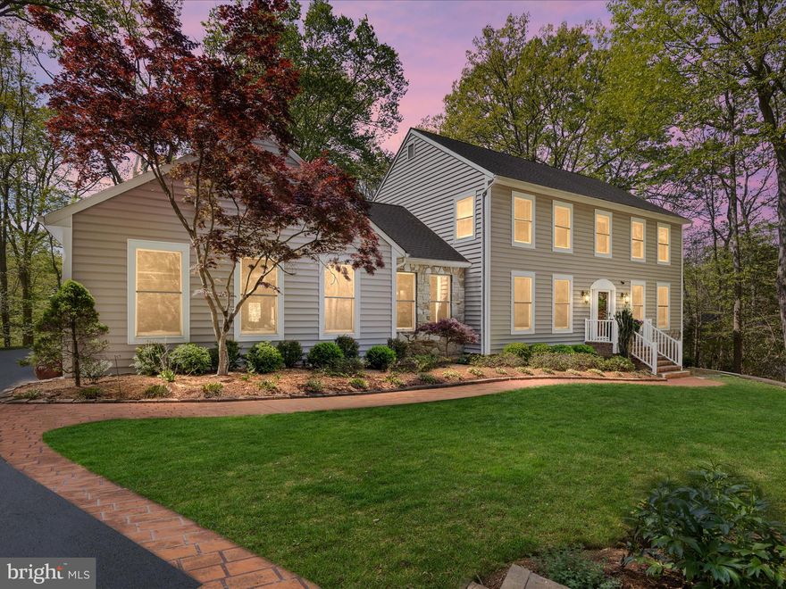 Welcome to your dream home nestled on a serene and wooded 1.11-acre lot! From the moment you step into the warm and inviting foyer, you’ll be captivated by the charm and elegance this spacious home has to offer. Gleaming hardwood floors flow throughout most of the main level, creating a seamless and welcoming atmosphere. To your left, the formal living and dining rooms are bathed in natural light from large, bright windows—perfect for hosting gatherings with family and friends. Just beyond, the heart of the home awaits: an upgraded kitchen designed for both everyday living and inspired home cooking. Featuring an oversized center island with a flat-top range, granite countertops, 42-inch cabinets, under cabinet lighting, stainless steel appliances, tile flooring, and a pantry, this kitchen is truly a chef’s delight with tons of storage. The cozy breakfast nook and built-in wet bar make it easy to start your mornings with ease or entertain in style.The spacious family room offers a perfect place to relax, highlighted by a stunning stone-wall fireplace and access to a lovely screened-in porch. Also on the main level, you’ll find a convenient bedroom and full bath, a generously sized mudroom with abundant storage and the laundry area offers direct access to the three car garage. Upstairs, the enormous primary suite offers a true retreat with dual walk-in closets and a luxurious en-suite bathroom complete with a jetted soaking tub, separate shower, and large vanity. Two additional bedrooms, each with ceiling fans and ample closet space, share a well-appointed hallway bathroom with an upgraded vanity and tiled tub/shower combination. The expansive walkout basement provides endless potential, with plenty of storage space and room to finish to your taste—perfect for a future recreation room, home theater, or private office space. Outside, enjoy peaceful moments and fun-filled gatherings on the screened-in porch and deck, or the large rear patio, complete with a wood burning oven (custom made using Forno Bravo plans) for steaks, pizza or even bread!  You will also find a cozy fire pit, and a beautifully landscaped front and rear yard with lighting throughout the driveway, walkway and rear.  Even your pets can run around comfortably with a pet door and invisible rear fence.  You can even hike down to the Bacon Ridge Creek in your own backyard!  An extra wide driveway and oversized three-car, side-loading garage with work bench and EV outlet offer plenty of parking and storage. Tucked away on a private, wooded lot, this home offers the perfect blend of space, comfort, and natural beauty. Both A/C units replaced 2021, HVAC 2021/2024. Just minutes to the Naval Academy and Fort Meade with easy highway access to 450, 50 and 97.  **Offer deadline Monday 5th  at 5pm. Please submit your best and final**