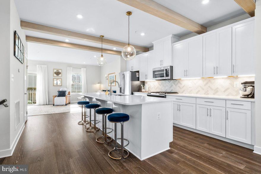 Welcome to 10327 Quillback Street, a truly one-of-a-kind luxury townhome located in the highly sought-after Lake Linganore – Oakdale community. Offering approximately 2,400 square feet, this beautifully upgraded home features 3 bedrooms, 2.5 bathrooms, a finished walkout basement, a large fenced backyard, and a 2-car front-load garage—a rare combination in today’s market.

The main level showcases engineered hardwood flooring throughout, complemented by oak hardwood stairs and stunning custom details. The gourmet kitchen is a showstopper with white soft-close cabinetry, high-end white quartz countertops, a herringbone backsplash, and exposed ceiling beams that add warmth and character. The open living area features a built-in electric fireplace, while the dining room’s bay window fills the space with natural light.

Upstairs, the primary suite offers a luxurious retreat with a custom accent wall and electric fireplace, a spa-inspired bathroom featuring a soaking tub, and a walk-in shower with frameless glass door. Thoughtful finishes and elevated design details continue throughout the home, making it both stylish and functional.

Enjoy resort-style amenities including four private pools, miles of scenic nature trails, playgrounds, picnic areas, dog parks, and private lake access, all within the coveted Oakdale School District.

There is truly no other townhome like this on the market—don’t miss the opportunity to own a home that perfectly blends luxury, comfort, and community living. Schedule your private showing today before this exceptional property is gone!