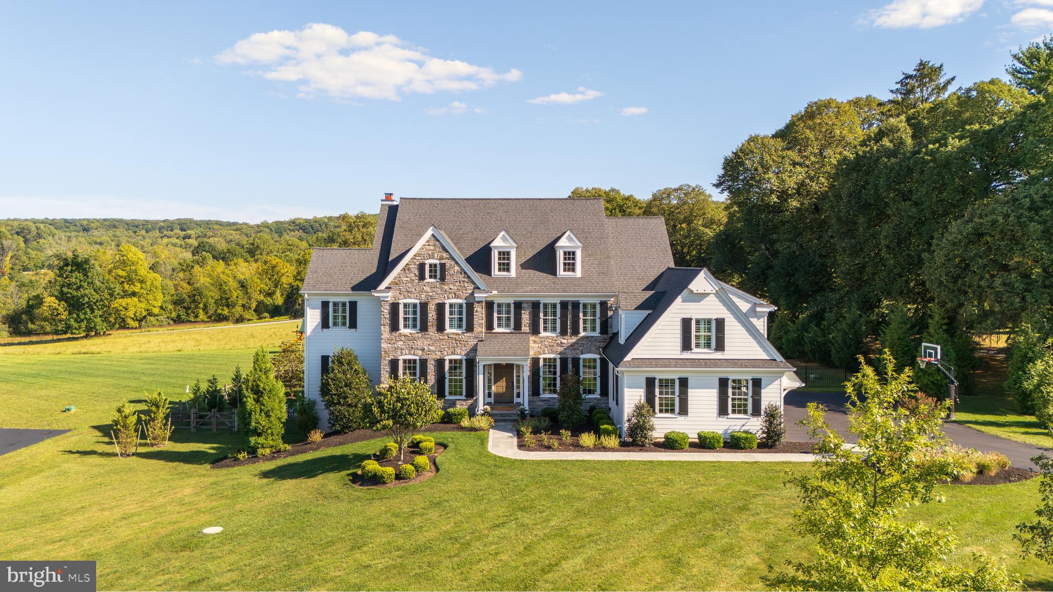 Prepare to fall in love with this exquisite collection of architecture, design, custom finishes, attention to details, manicured landscape and uncomparable indoor and outdoor living spaces. All set on a premier homesite in the highly regarded Cedar Run community in a coveted Malvern location. This remarkable estate home was brought to life under the artful direction of renowned architect Mark Stanish and hand crafted by Hellings Custom Builders and is ready to pass along to the most discerning and sophisticated buyer. This home represents a perfect and harmonious blend of classic tasteful finishes, comfort and amazing seamless indoor and outdoor living experiences. The end result is a property that presents in mint condition and offers turn key living like no other. 24 New Whitehorse Way encompasses a private refined setting, grand manor details including 6" Mica stone facade, Pella windows, mahogany front and side entry doors, bluestone and Belgium block walkways, formal and informal gardens, astounding distant views changing with every season, blue stone patios with mica stone walls, Infinity "faux edge" salt water pool with integrated spa, waterfall and sun shelf for those summer days, "cool to the touch "porcelain flooring at the pool surround, stately covered porch with raised hearth floor to ceiling mica stone wood burning fireplace, TV and speakers throughout this entertaining oasis, a true definition of staycation. Upon entering this fine home you will engage countess features and hallmarks including; A welcoming grand entry foyer, custom pilaster cased openings, open staircase w/ mahogany rail to all three living levels, striking living and dining rooms, expanded private study with custom built -ins to include desk area and printer cabinet. formal and informal powder rooms, magnificent sun drenched fireside great room with coffered ceiling and built-ins offering direct access to the outdoors, vaulted glassed morning room with oversized windows enhancing the views, chefs kitchen with Wolf double oven 6 burners plus griddle range, Sub Zero refrigerator and hand selected marble countertops topping the striking white kitchen accented with lit glassed cabinetry and under cabinet ambient lighting, walk in pantry and service ready butler pantry, off the kitchen access to the outdoor living spaces including Lynx grilling station and refrigerated entertaining wet bar, servicing both the covered porch, patio and pool areas, attractive mudroom and enhanced 3 car garage complete this stellar main floor. Upstairs you will be greeted by an attractive upper hall, a primary retreat offering distant views, his/hers custom closets and a spa-like bath with glass shower showcasing the natural stones and mosaics while enjoying the multiple shower heads to include a soothing rain shower. There are 4 additional generous sized bedrooms on the second floor, including 2 ensuite and 2 serviced by a J&J bath, all have custom closet organizers w/drawers for a more refined living plan. The well appointed upper floor laundry completes the level. It does not stop there, the daylight walk out lower level will not disappoint. This area consists of a spacious entertaining / media room including refrigerated wet bar, private Gym and 2 additional flex rooms that can be used for numerous purposes including: office, playroom or crafting room just to name a few. The lower level powder room is positioned across from the door leading to the pool area. Addition enhancements include: whole house generator, plantation shutters, custom paint throughout, Visual Comforts and Schonbek designer lighting, exterior landscape lighting, site finished hardwood flooring on main level and entire second floor to name a few. This home is full of designer finishes extraordinary outdoor living spaces, uncompromised privacy and curb appeal galore. Enjoy its close proximity to major roadways and all the dining an attractions the Main Line has to offer.