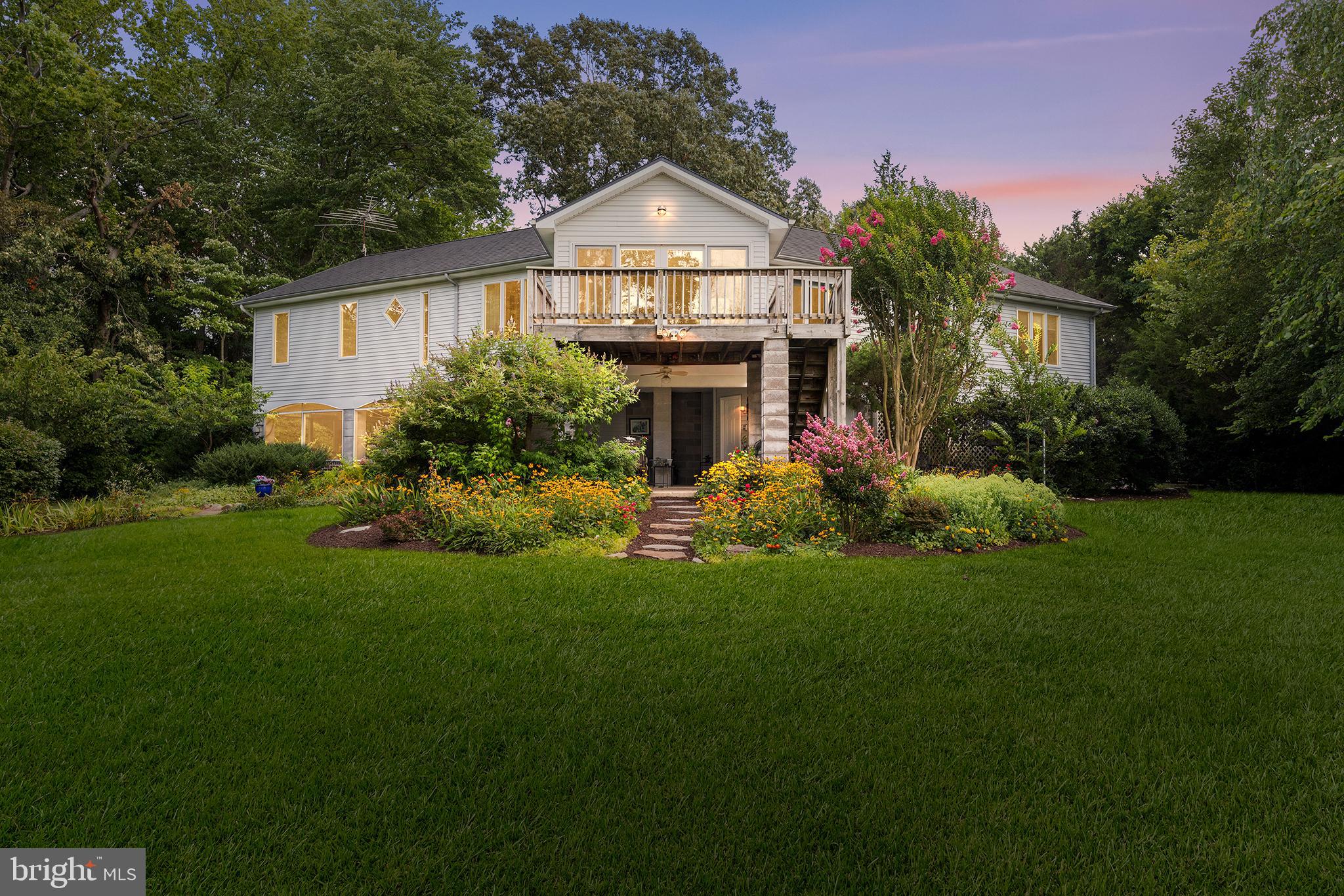 Welcome to a rare opportunity for luxury waterfront living on the Chester River. This beautifully maintained 3-bedroom, 2.5-bath home offers over 2,000 square feet of living space, thoughtfully designed to embrace both comfort and elegance. Set on 1.08 acres of lush, well-landscaped grounds, this exceptional 2001-built two-story residence offers a park-like, deep, well-landscaped and level setting directly on the water—a combination seldom found. With 170 feet of private water frontage with riparian rights, a sandy beach, deep-water pier, boathouse, and captivating river views, this property is equally ideal as a full-time residence or a serene second-home retreat. As you enter through the front door, you can either take the stairs to the main living level or enjoy the convenience of an elevator, providing easy access for all and enhancing the home’s overall accessibility. Inside, the main level showcases an open-concept design with vaulted ceilings and walls of glass that frame the tranquil waterfront with the great room is anchored by a floor-to-ceiling brick hearth. The expansive three-season room leads to a spacious deck overlooking the Chester River, complete with a walk-down to the lower-level patio, creating seamless flow between upper and lower outdoor living spaces. Additional main-level highlights include an open office space with built-ins, formal living and dining areas, and a flexible family room that can be used as a craft space, office, or additional living area. The primary suite features peaceful water views, spacious closet, and a private ensuite bath, while the secondary bedrooms are generously sized and share a full bath, providing comfort for family or guests. The lower level is designed for effortless entertaining, opening to a spacious patio and large screened-in porch. This area includes access to a private 1/2 bath and a bonus room with refrigerator, making it ideal for outdoor dining or large gatherings. Whether you're hosting intimate get-togethers or celebrations of any size, this space delivers the flexibility and amenities to entertain in comfort and style. An outdoor hot water shower is perfect for rinsing off after a day on the water. This level also provides access to the attached single-car garage and a fully enclosed carport, offering ample space for vehicles, watercraft, or yard equipment. The backyard is not only park-like, but also deep, well-landscaped, and level, with vibrant perennials, mature trees, manicured walkways, and a tranquil Zen garden. It’s an ideal setting for outdoor living, recreation, or simply enjoying the stunning natural surroundings. Step out to your private deep-water pier—perfect for boating, crabbing, fishing, or relaxing with a glass of wine as the sun sets and the serene sounds of nature surround you. Modern upgrades include a Permalock aluminum roof (2023), built-in surround sound, audio/visual security system, and an emergency generator for added peace of mind. Located just minutes from the historic charm of Chestertown—yet privately tucked away—this waterfront property offers a rare blend of natural beauty, thoughtful design, and everyday convenience. Enjoy daily sightings of eagles, ospreys, herons, owls, deer, and more. And with an easy commute to Washington, D.C., Baltimore, and Philadelphia, this home is perfect whether you're seeking a luxury primary residence or a tranquil second-home escape. Schedule your private tour today—this is the lifestyle you've been waiting for.
