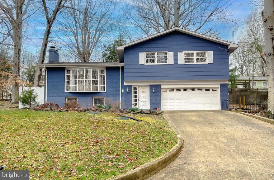Convenient access to a multitude of employment opportunities whether at cove point, Pax River, or Andrews, DC etc. Rural living within a water access community and a stellar home awaiting you to come home to everyday! This split level boasts a wide foyer that sets the tone for the rest of the space. As you enter, you're greeted by a spacious foyer that stretches upward and inward, giving a sense of openness. and tons of character. The hardwood flooring throughout adds a timeless, classic beauty to this home. The natural grain patterns and rich tones of this wood provide warmth and elegance that complements a wide range of interior design styles, from traditional to modern, move in and the options are limitless for your decorating needs. 
Up the second set of  steps you'll be greeted by all 3 bedrooms and 2 full bathrooms, also showcasing hardwood flooring. The lower level provides a very large family room, another bathroom and a large laundry room with ample storage. 
The double car garage is directly connected to the home, offering easy access. This seamless connection makes it especially useful for bringing in groceries, unpacking items, or avoiding bad weather. Not to mention the storage space. There is an additional small office space / hobby room on the main level. The large lot offers private space on the side of the home and ample parking space in the driveway.