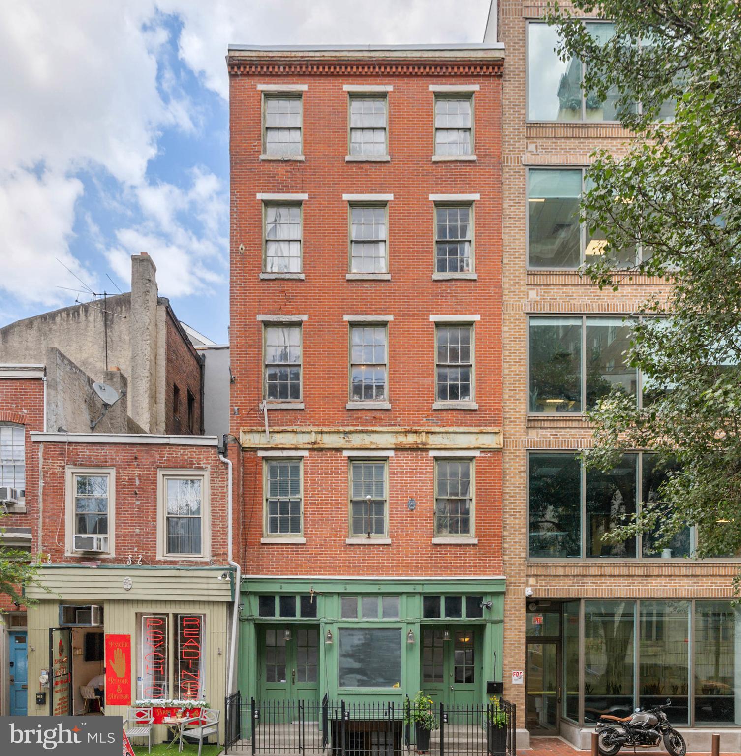 105 S 2nd Street is a huge 5-story quadruplex offering modern updates and original character in the heart of Old City/ Society Hill. Zoned for mixed use, the property currently has studios on the lower, first, and second levels, plus a 2-bedroom, 2.5-bathroom apartment on the top three levels. The building would also be ideal for a storefront or a private single-family residence. Out front, there's a towering red brick facade befitting the neighborhood and a locking gate for added security. Steps at the center descend to a unique studio with lots of exposed wood and brick. There's plenty of space for hanging, working, and sleeping, along with a mini kitchen, a modern bathroom, and cool windows into the building's historic past. The unit on the first level has a private entrance that leads to a bright and airy space boasting gleaming hardwood floors, a full kitchen with a dishwasher, a laundry pair, and a full bathroom. A final doorway and staircase lead to the remaining apartments. The second floor has another large, modern studio with hardwoods and bright windows. Topping off the property is the biggest apartment. Its main level has hardwood floors, a living room featuring tall windows and built-ins, an open kitchen with counter seating, a laundry closet, and a half bathroom. Each of the upper levels has a large, sunlit bedroom suite with a full bathroom. In addition to everything inside, this unbeatable location earns a Walk Score of 99! The surrounding blocks are filled with some of the city's best shopping, dining, and entertainment. History is on display nearby at Independence Mall, plus a sprawling new riverfront park under construction will add to the hangout spots and holiday events steps away along the Delaware. There's also easy access to Pennsylvania and Jefferson Hospitals, public transit, I-95, I-676, and South Jersey. Schedule your showing today!