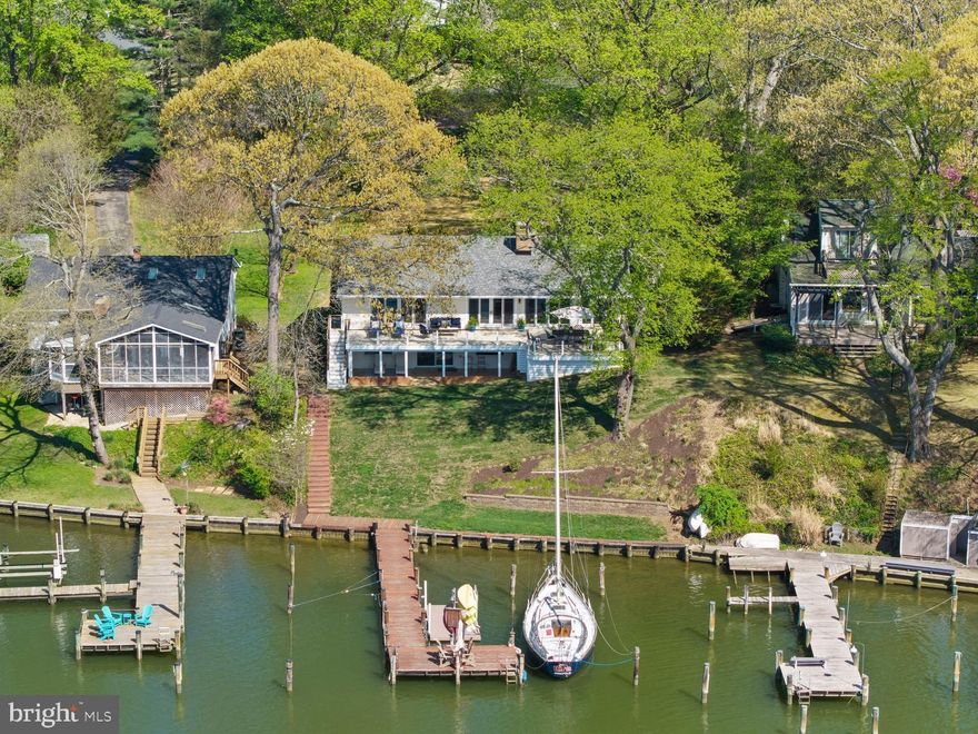 Burley Creek, with its direct passage to Whitehall Bay and the Chesapeake Bay, sets a serene and picturesque stage for this thoughtfully designed waterfront residence, where daily living is effortlessly intertwined with the water.

Countless improvements throughout the years (see improvements list in Documents) has created a beautiful turn-key, low maintenance property perfect for starting your life on the water! The main level unfolds with an open, light-filled floor plan centered around a gourmet kitchen with a spacious island, flowing effortlessly into the dining area. Multiple sliding glass doors line the waterside, opening to an expansive deck that spans the full width of the home, creating a natural extension of the living space and an ideal setting for entertaining or simply enjoying the ever-changing views.

The living room is anchored by a striking double-sided brick fireplace, offering warmth and architectural character while connecting the main gathering spaces. Just off the foyer, a private bedroom with ensuite bath provides a perfect guest retreat. The main level also features a well-appointed primary suite with its own ensuite bath and direct access to the deck, allowing for a quiet, personal connection to the waterfront. An additional bedroom and hall bath complete this level.

The lower level offers a comfortable extension of the home with a family room that opens to a covered patio, inviting easy indoor-outdoor living. A conveniently located powder room and two additional bedrooms sharing a full bath, offer flexibility for guests, recreation, or home office use.

The outdoor experience is equally compelling, with a private pier featuring multiple slips, a floating dock ideal for launching kayaks and paddleboards, and a generous waterside seating area designed for gathering and relaxation. A long driveway leads to an expansive parking pad, providing ample space for guests, while a large storage shed offers abundant room for water toys, lawn equipment, and seasonal essentials.

Located in the Blue-Ribbon Broadneck School district and just 5 miles to downtown Annapolis and Severna Park. Convenient to Baltimore, BWI, Ft. Meade/NSA and Washington, DC., the location provides the very best this region has to offer in a 30-mile radius. Welcome Home!