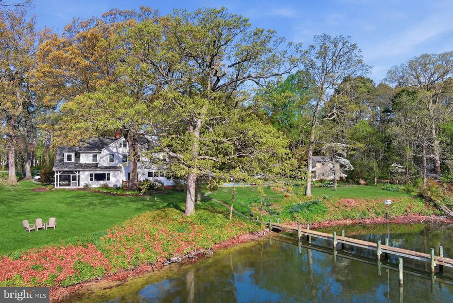 Professional Photos Coming**Set on 2.32 glorious acres overlooking Dixon Creek, this beautifully and lovingly maintained 1915 residence offers timeless character, refined comfort, and exceptional waterfront living. Original hardwood floors run throughout much of the home, while expansive windows bathe the traditional floor plan in natural light and frame expansive water views from nearly every room. The main level features gracious formal living and dining rooms, a gourmet kitchen with a beautiful center island and top-tier stainless appliances, and a welcoming family room with wood-burning fireplace. Custom built-ins are thoughtfully integrated throughout the home, reflecting quality craftsmanship and attention to detail. Upstairs, the waterside primary suite offers a fireplace, dual walk-in closets and a luxurious ensuite bath with soaking tub and glass-enclosed shower. Two additional guest bedrooms include one with an ensuite bath and another with access to the hall bath. The third level provides a flexible bonus room, ideal for an office, studio, or additional living space. Outdoor living is equally inviting, with a waterside screened porch, a poolside screened patio with wet bar, and an additional open deck off the dining room—perfect for enjoying the tranquil setting. The beautifully landscaped grounds feature mature trees, lush plantings, and extensive hardscaping, anchored by a stunning gunite pool with expansive deck and surrounding gardens. Additional structures include a charming former icehouse (currently used as a storage shed) and a larger outbuilding once used as tenant quarters. An attached 2-car garage and a full encapsulated basement offer excellent functionality and versatility. With 280 feet of natural shoreline, a private pier with two slips, boat lift, and 3.5–4' MLW, this property captures the essence of Eastern Shore waterfront living.
*Septic replaced in 2020 and is for 4 bedrooms-owners have plans to share for first floor primary